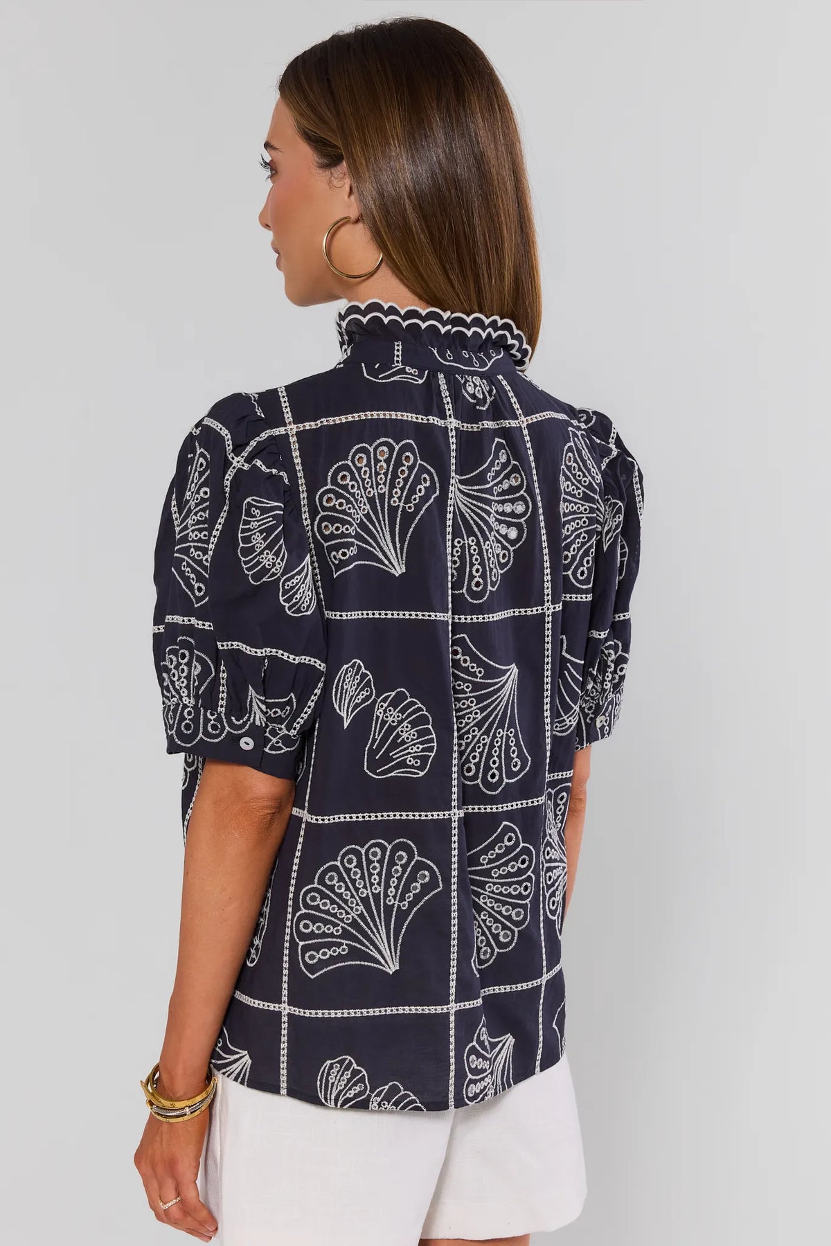 Navy seashell embroidered top back view showing puff sleeves, scallop collar, and allover coastal embroidery | Avara