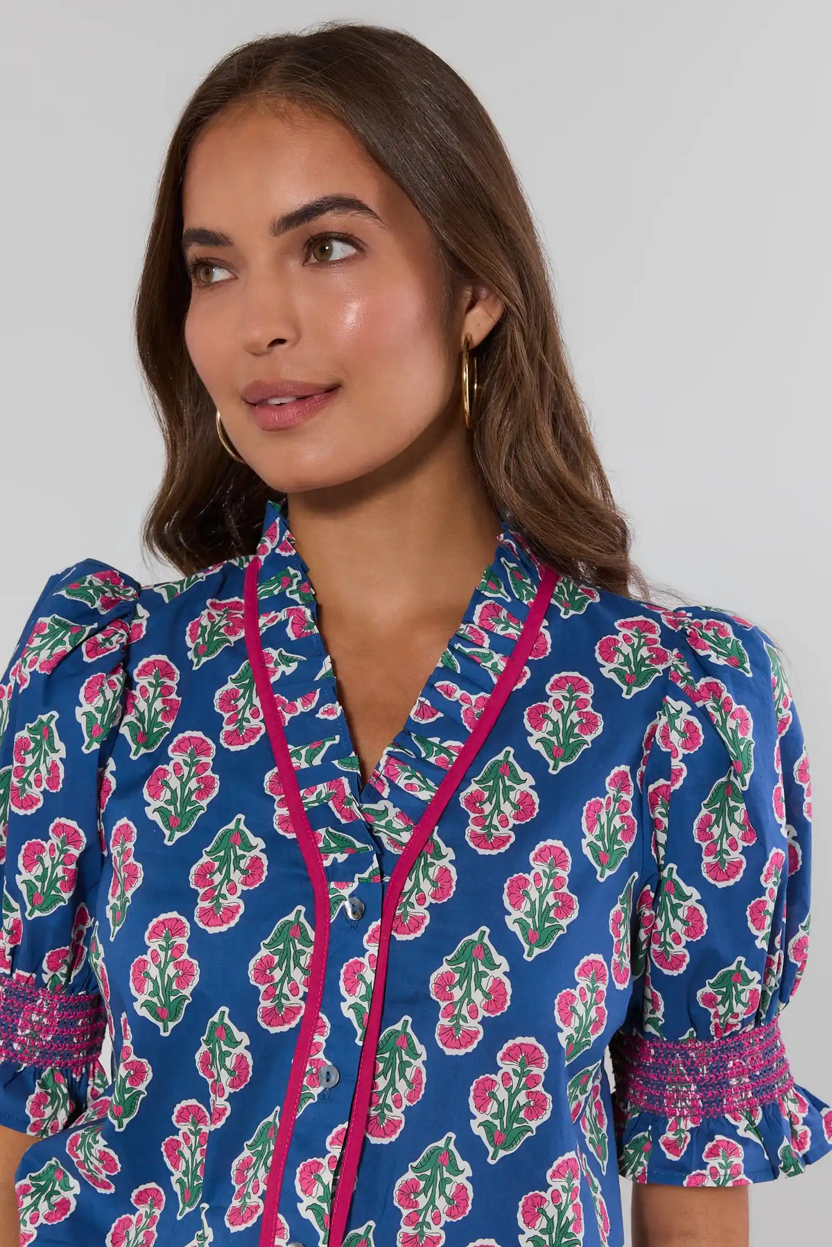 Navy printed smocked detail top with pink trim and ruffle cuffs - Close-Up Neckline Detail | Avara