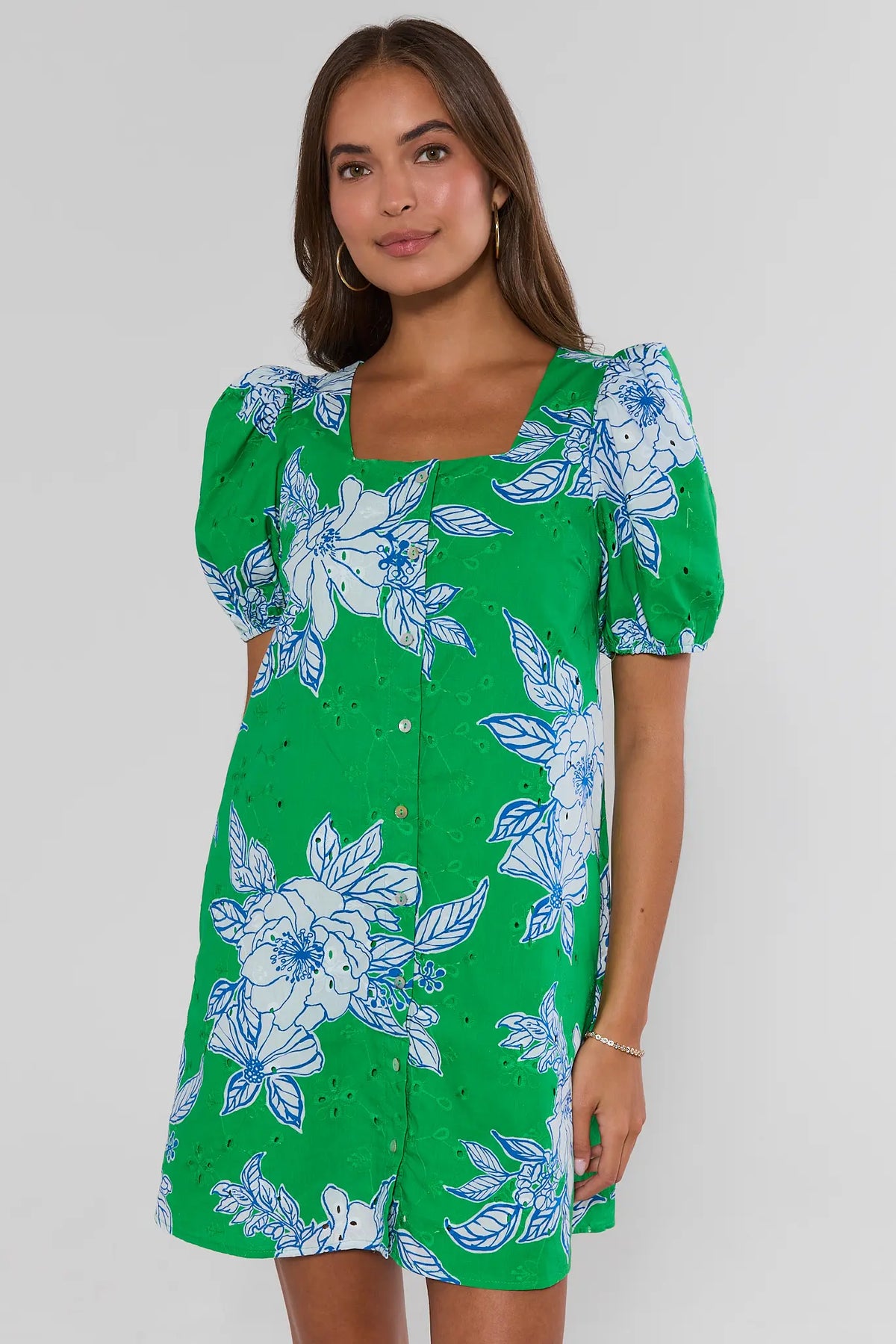 Green eyelet floral short dress with blue floral print and puff sleeves, full-length front view on model | Avara