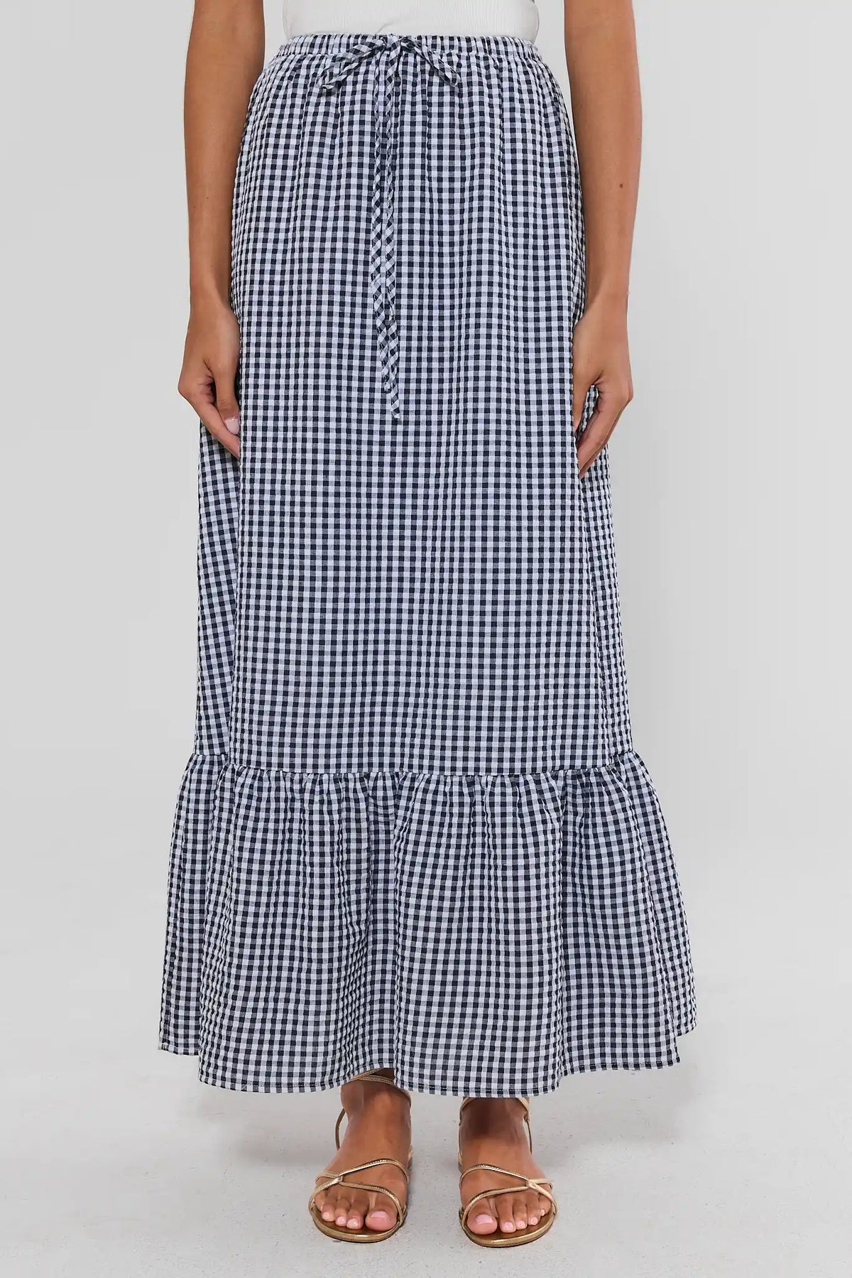 Navy and white gingham maxi skirt with drawstring waist and ruffle hem - Front View | Avara