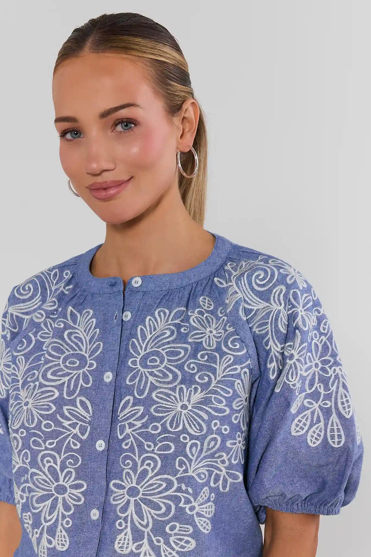 Laney Blue Embroidered Button Up Top - Close-Up Front Detail, white floral embroidery on chambray | Avara