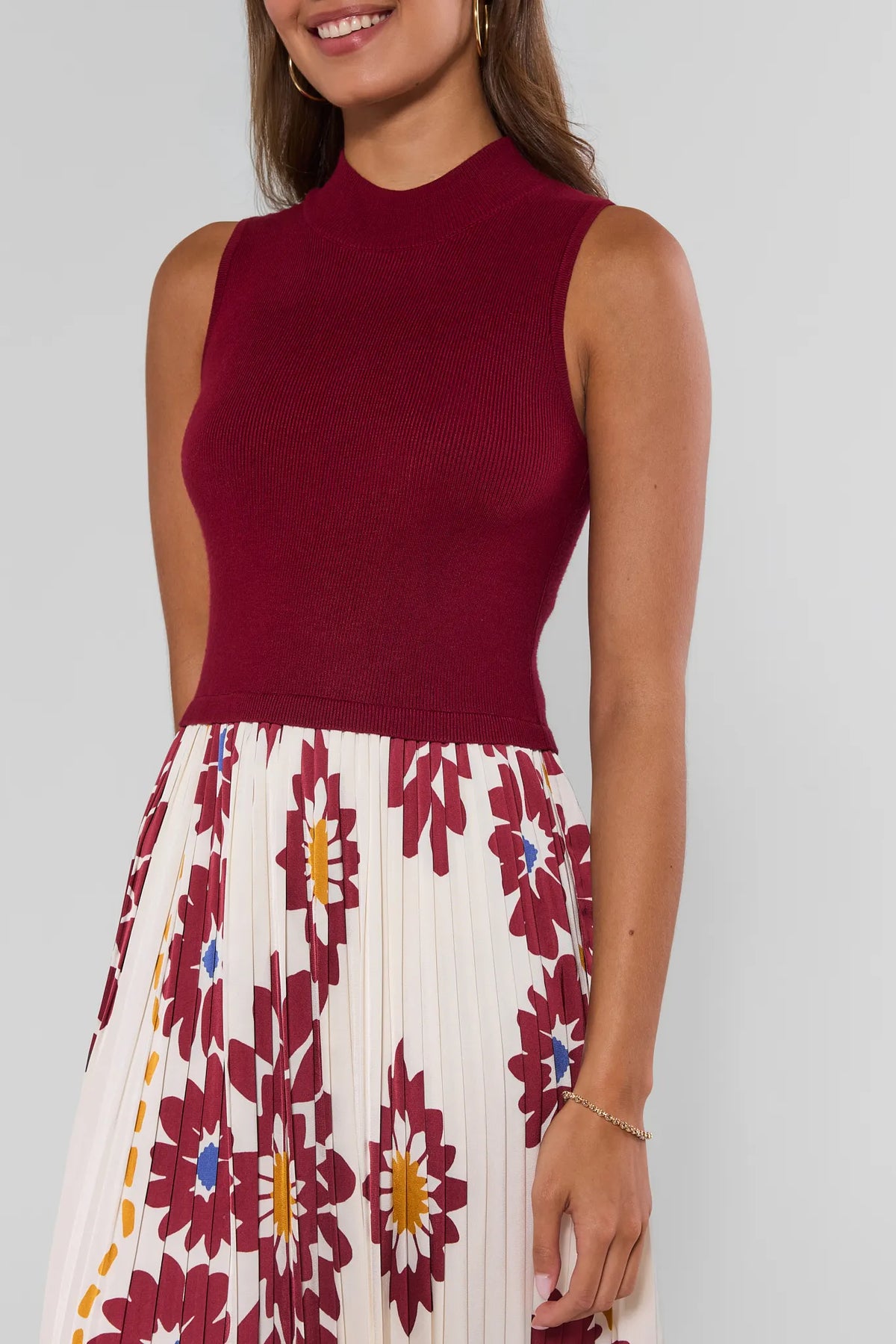 Close-up of Marcia Burgundy Midi Dress ribbed mock-neck bodice and bold floral pleated skirt detail | Avara
