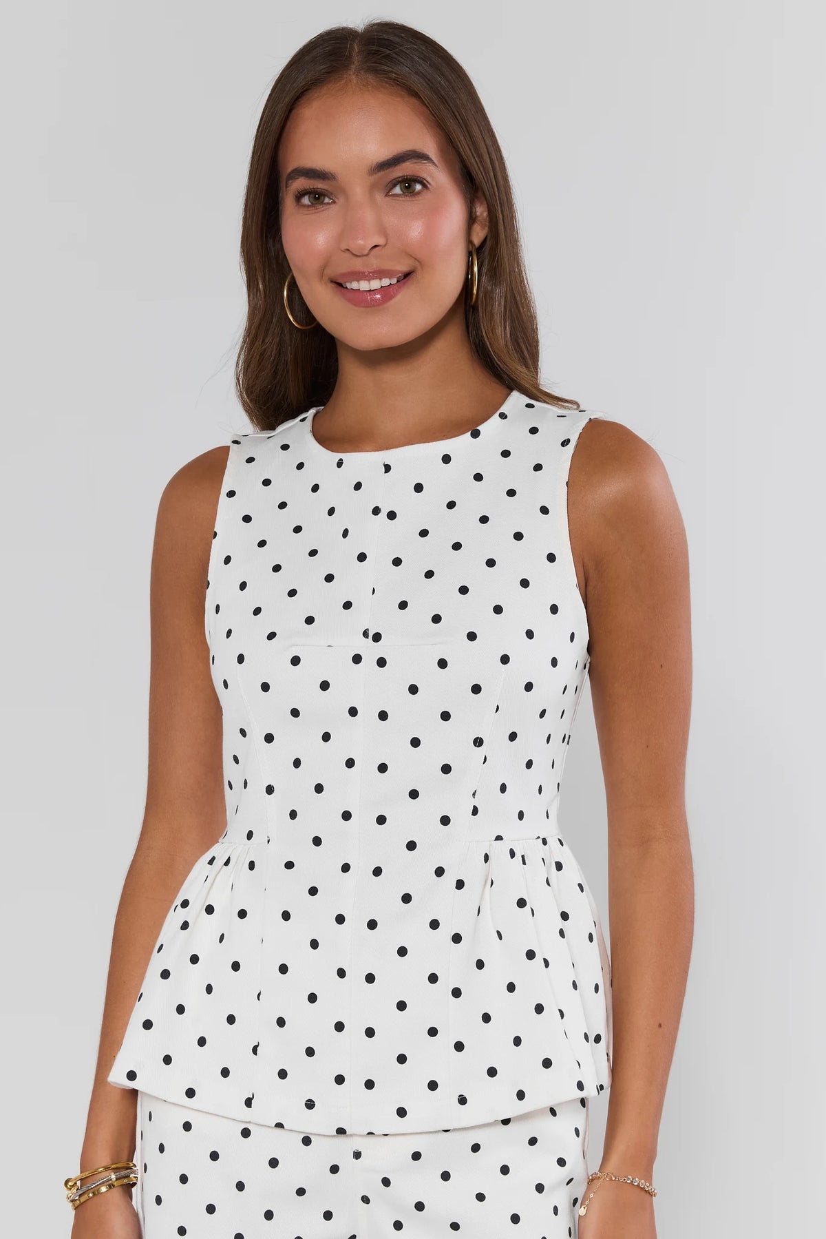 White polka dot peplum tank top on model, front view with matching set | Avara