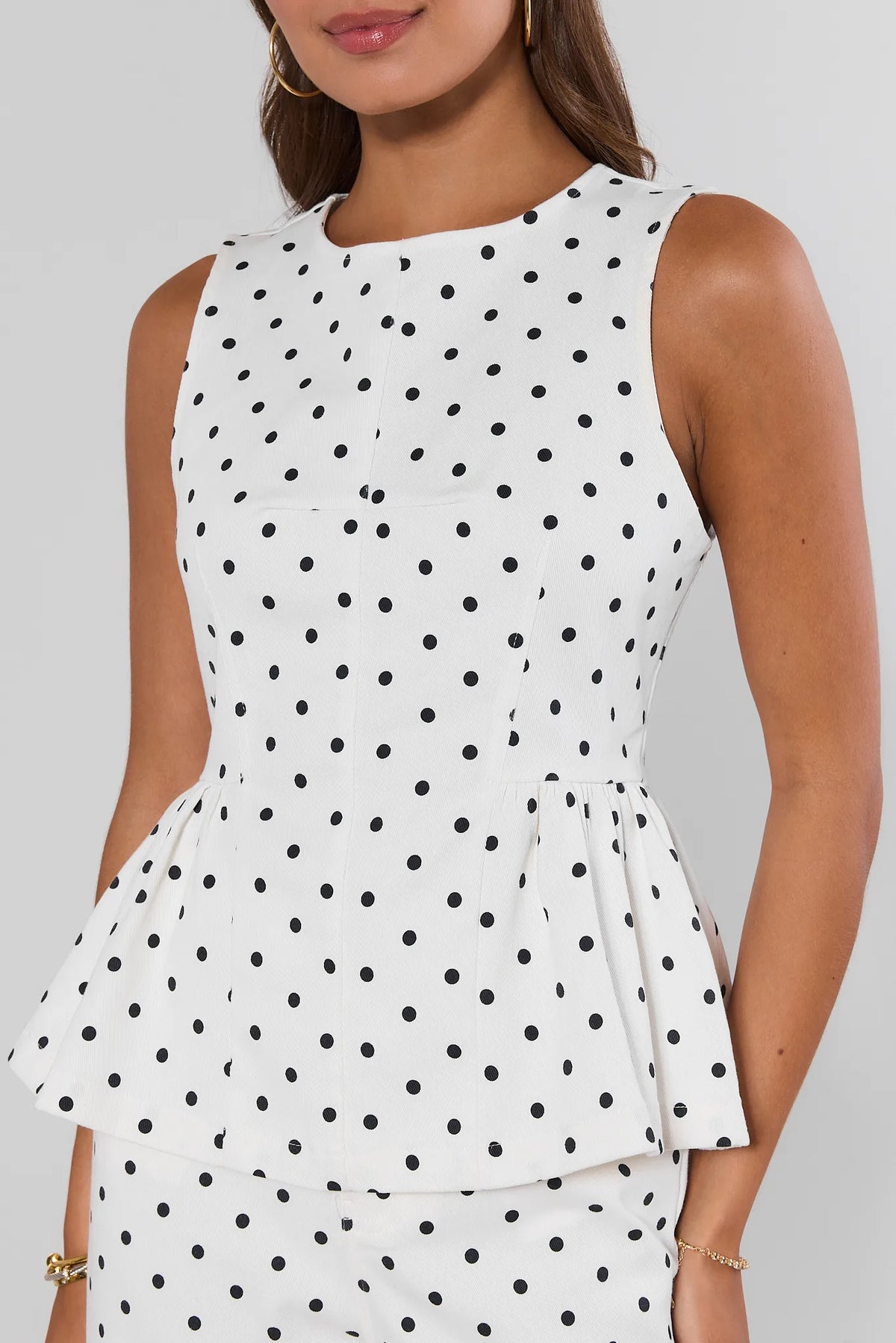 White black polka dot peplum tank top close-up detail, peplum hem and round neckline | Avara