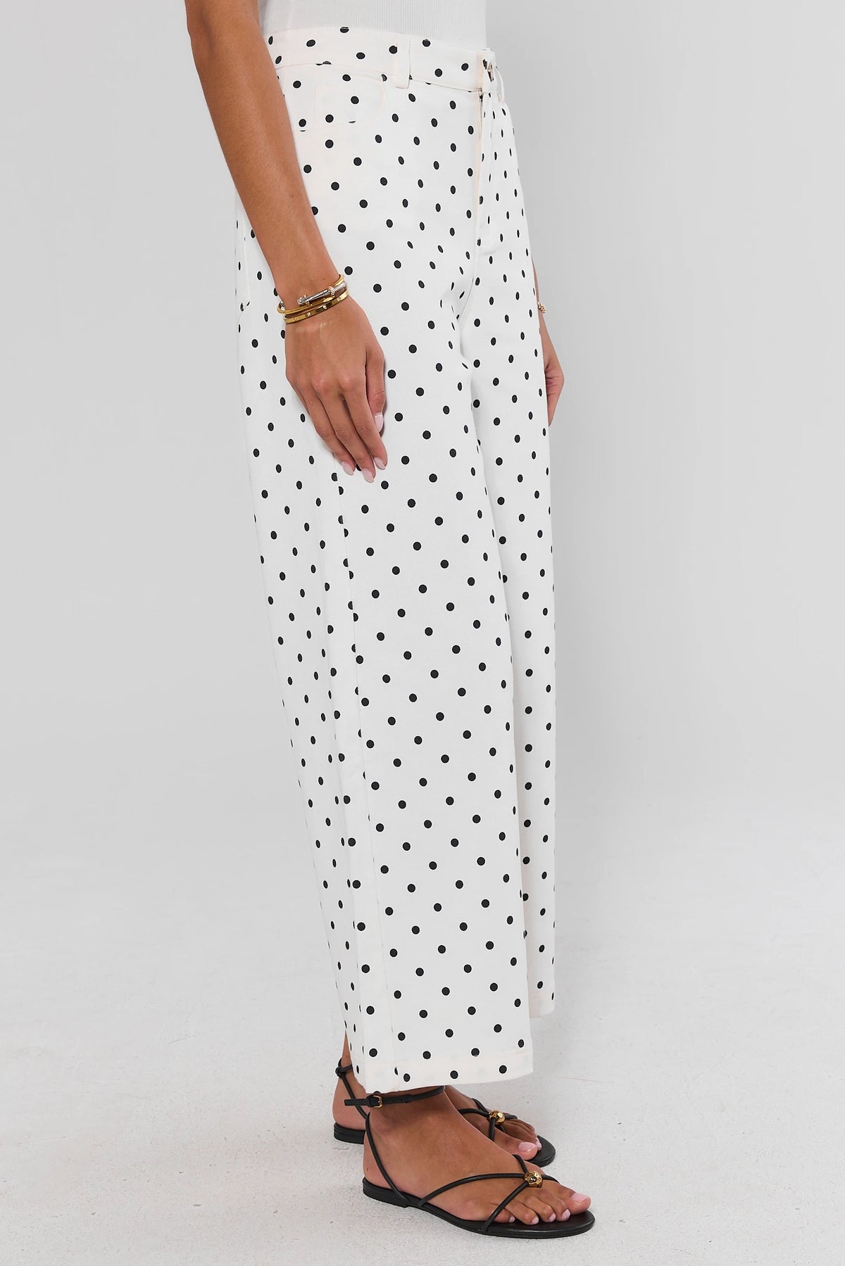 White pants with black polka dots, wide leg silhouette showing side profile and waistband detail | Avara