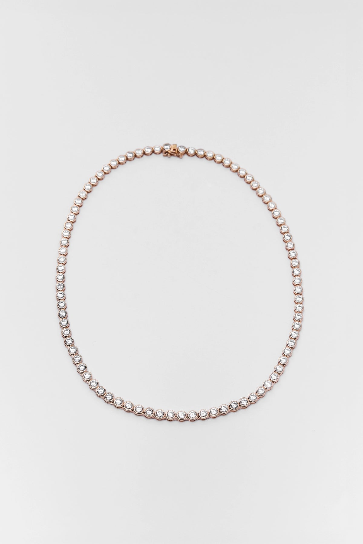 Gold Round Bezel Tennis Necklace with rhinestone details - Flat Lay | Avara