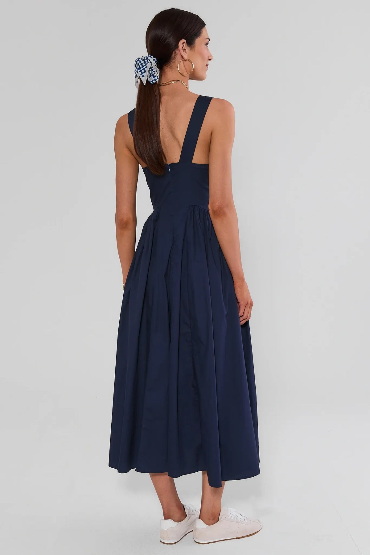 Navy gathered maxi dress back view showing wide straps, open back, and flowy gathered skirt | Avara