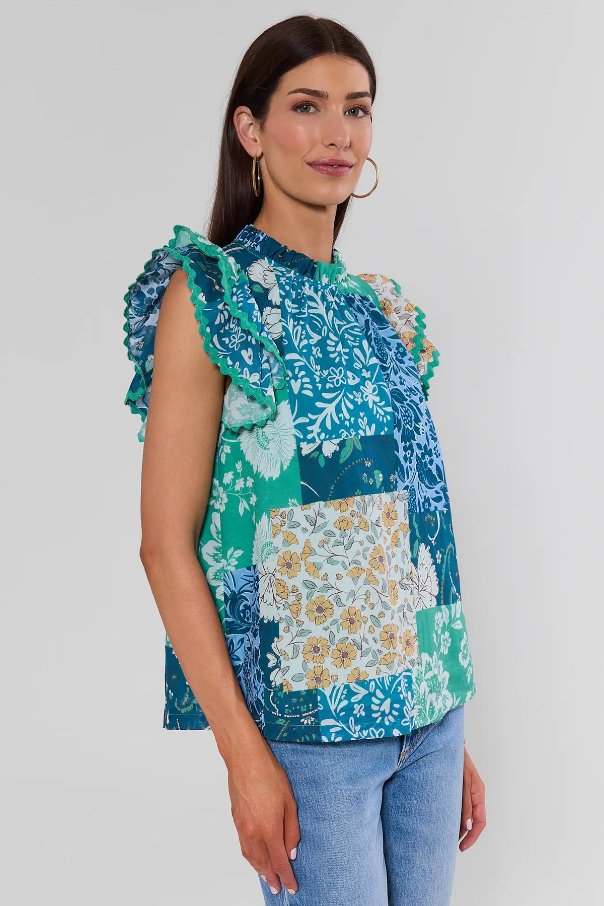 Green Multi Patchwork Print Top side view, flutter sleeves with ric-rac trim, styled with light wash jeans | Avara