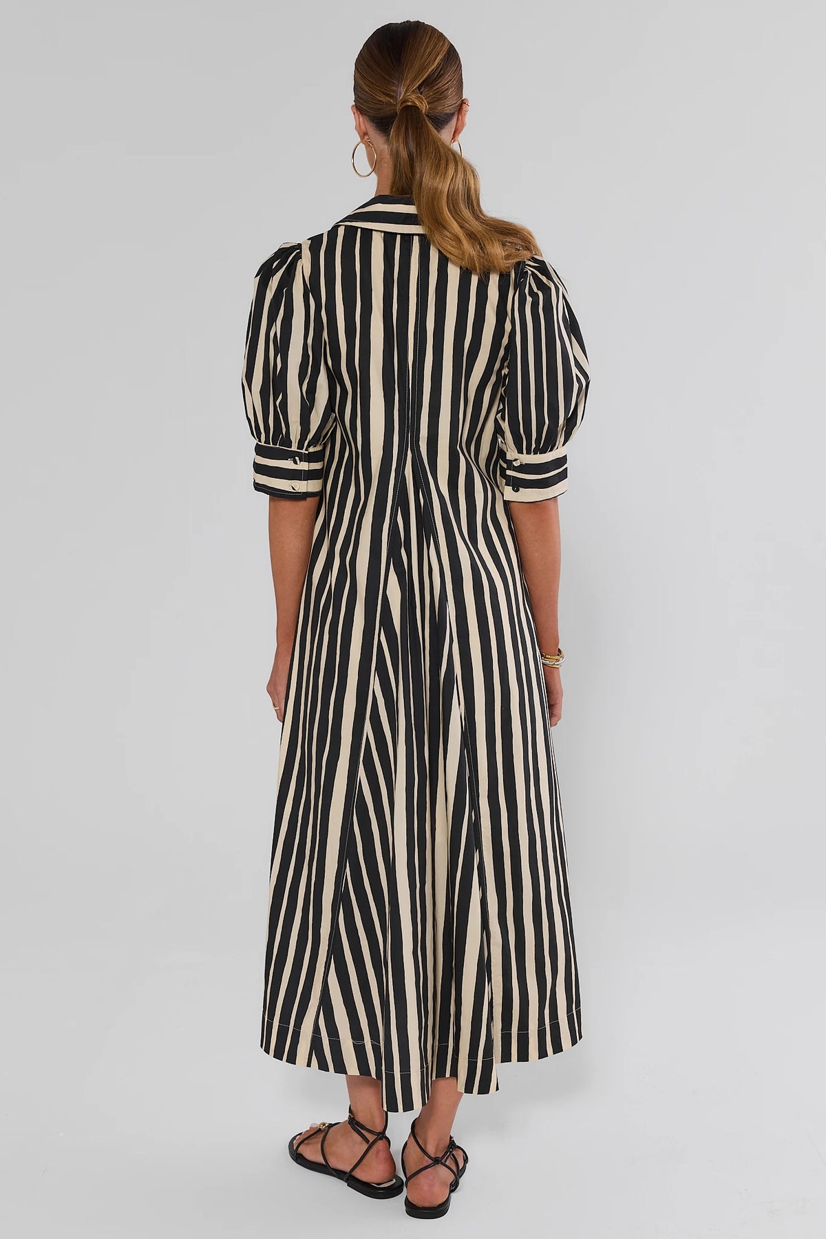 Isla Black Striped Midi Dress back view showing puff sleeves and A-line midi length, vertical stripe print | Avara