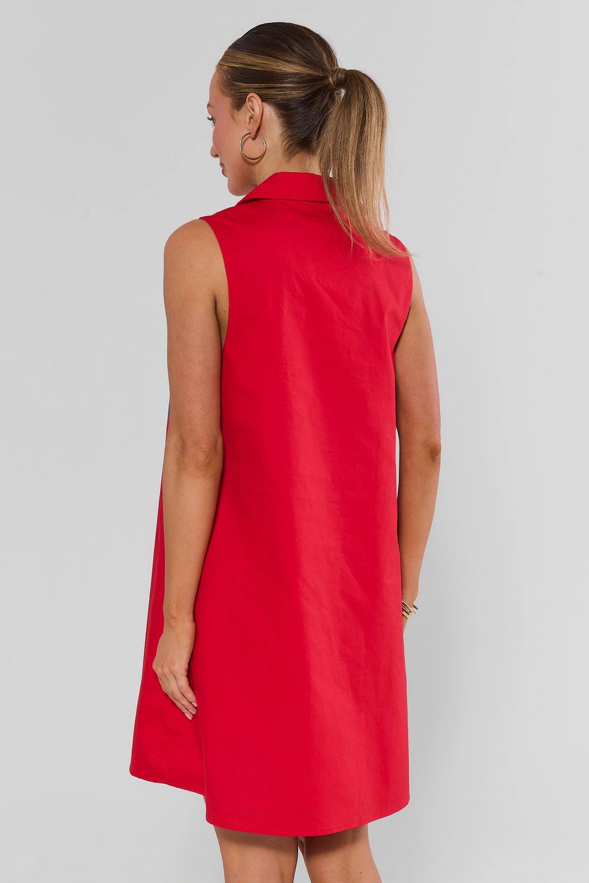 Woman wearing red Ellen Short Dress sleeveless shift silhouette - Back View | Avara