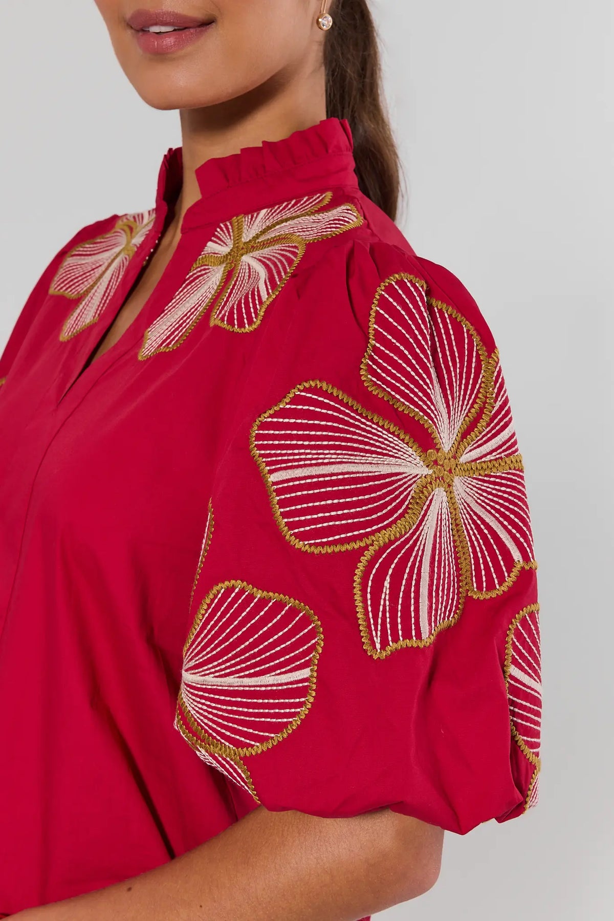 Close-up of red THML Harley Top showing gold and cream floral embroidery on puff sleeve and ruffle neckline | Avara