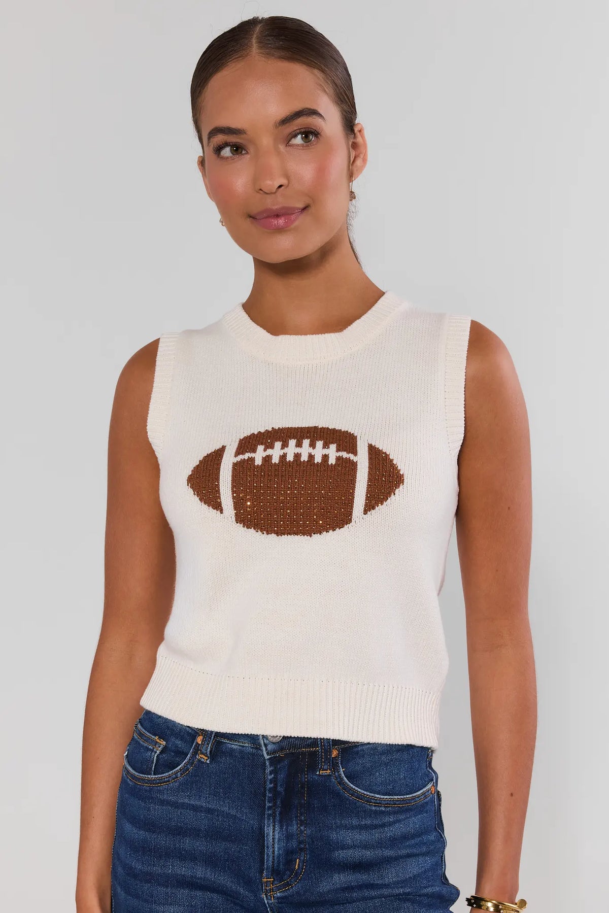 AJ White Football Sleeveless Knit Top front view on model with dark jeans, women's game day top | Avara