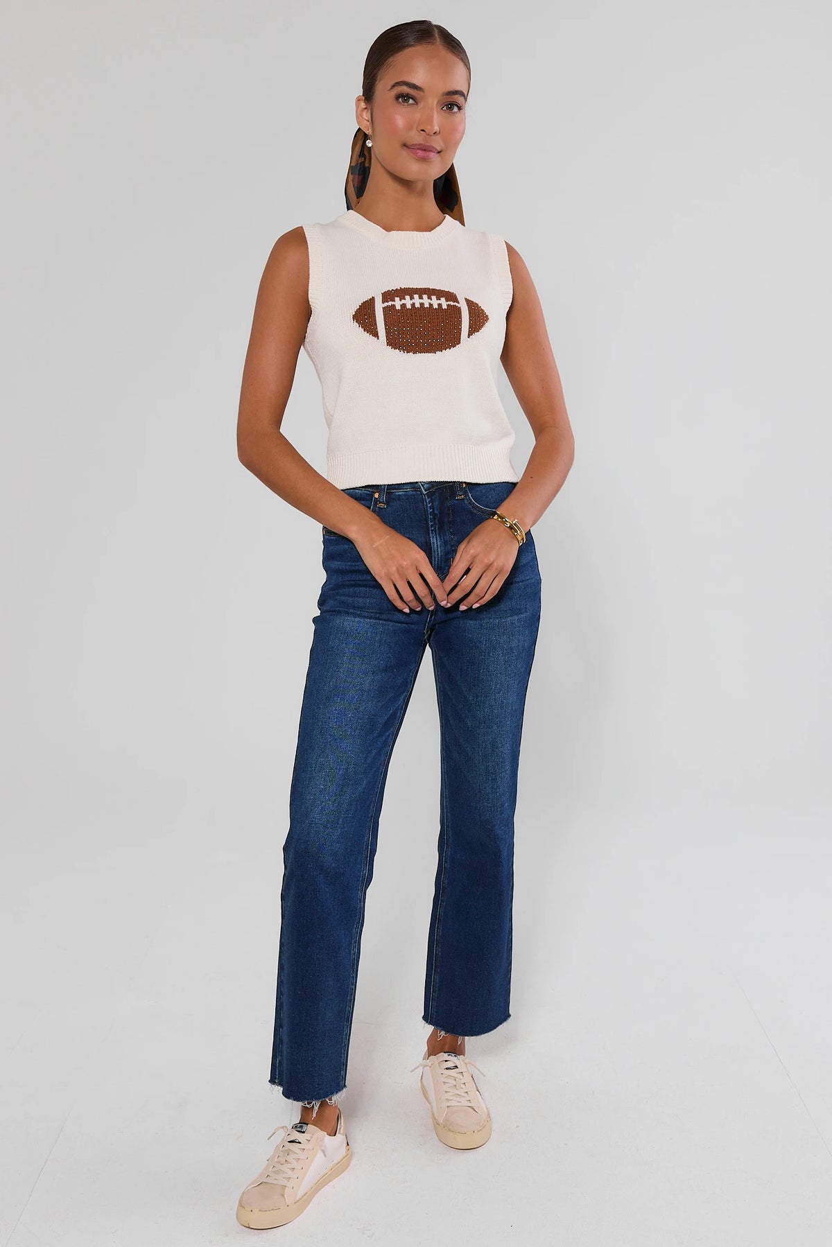AJ White Football Sleeveless Knit Top full-length front view styled with dark jeans and white sneakers | Avara