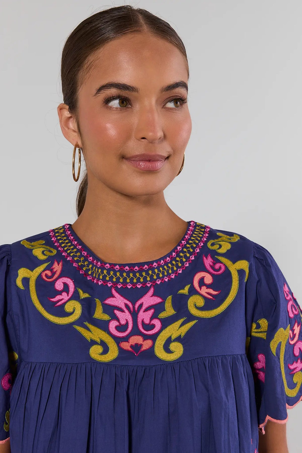 Close-up front view of navy THML embroidered scalloped top showing neckline embroidery detail | Avara
