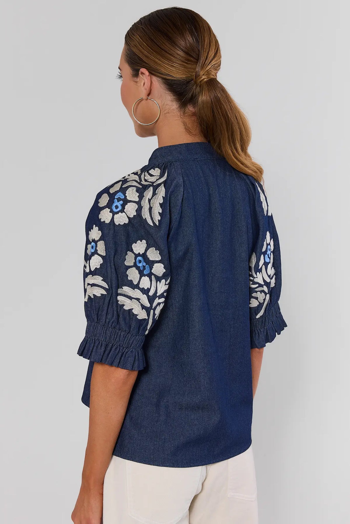 Woman wearing Navy Floral Embroidered Top by THML - Back View, Puff Sleeve Chambray Blouse | Avara