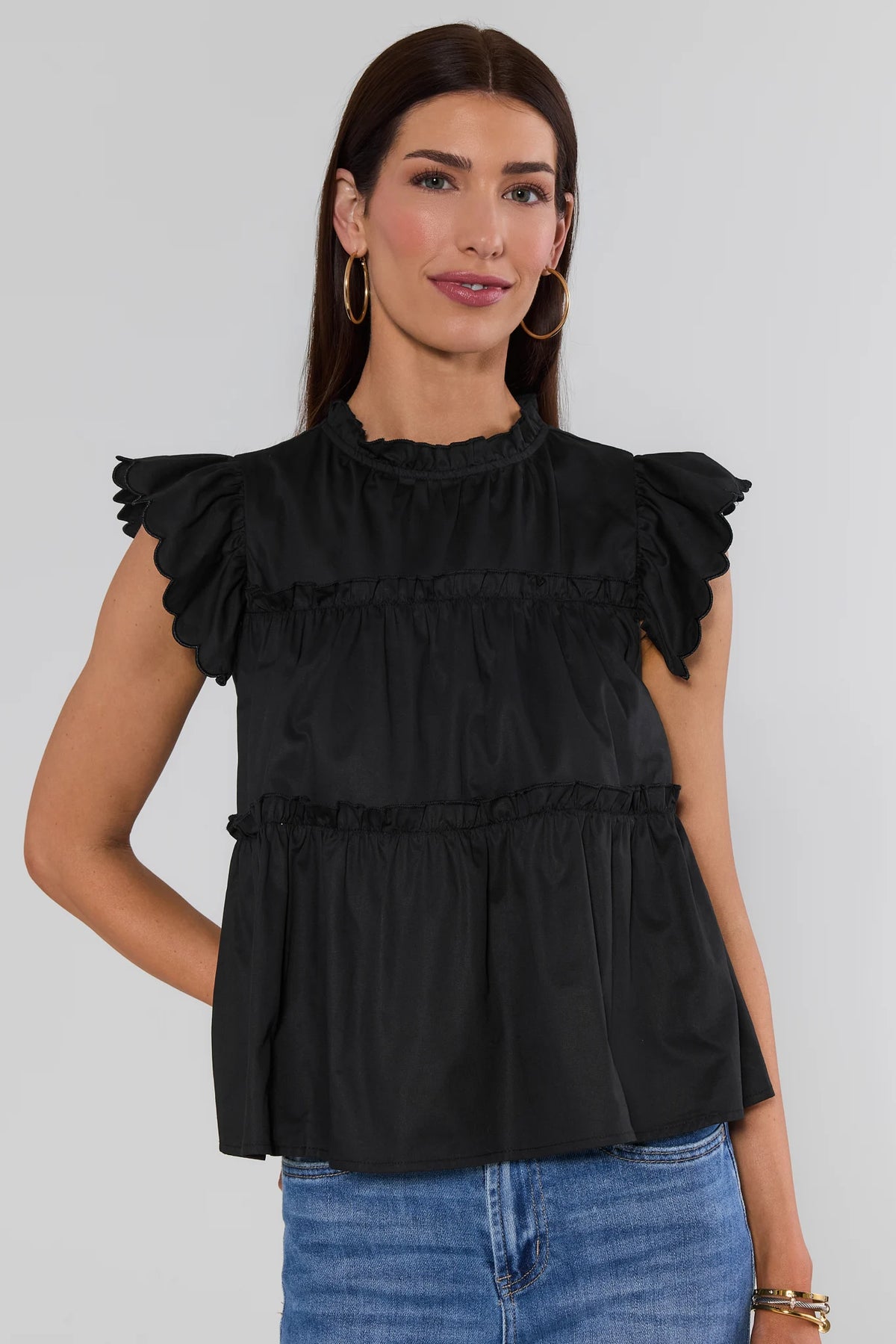 Woman wearing Black Tiered Flutter Sleeve Top with scalloped flutter sleeves - Front View | Avara