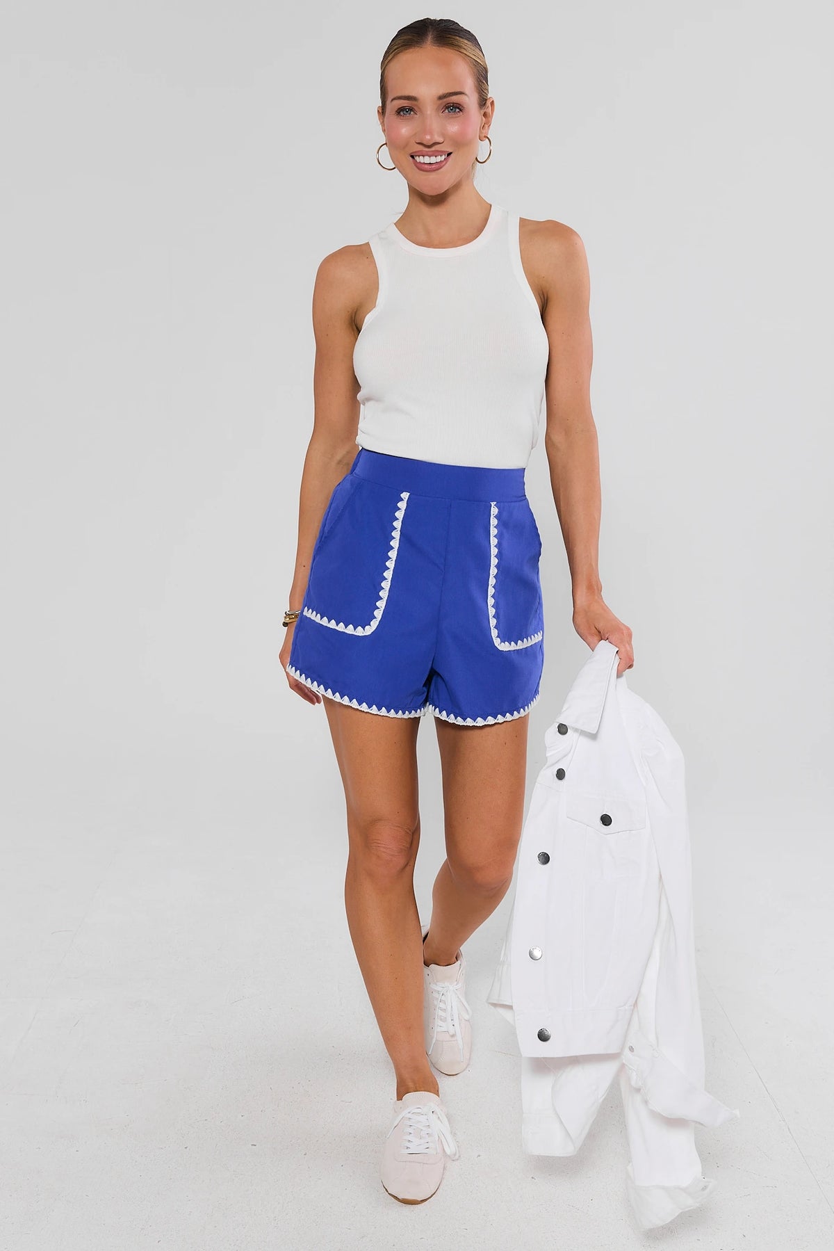 Woman walking in Blue Embroidered Trim Shorts styled with white tank and jacket - Full Body Look | Avara