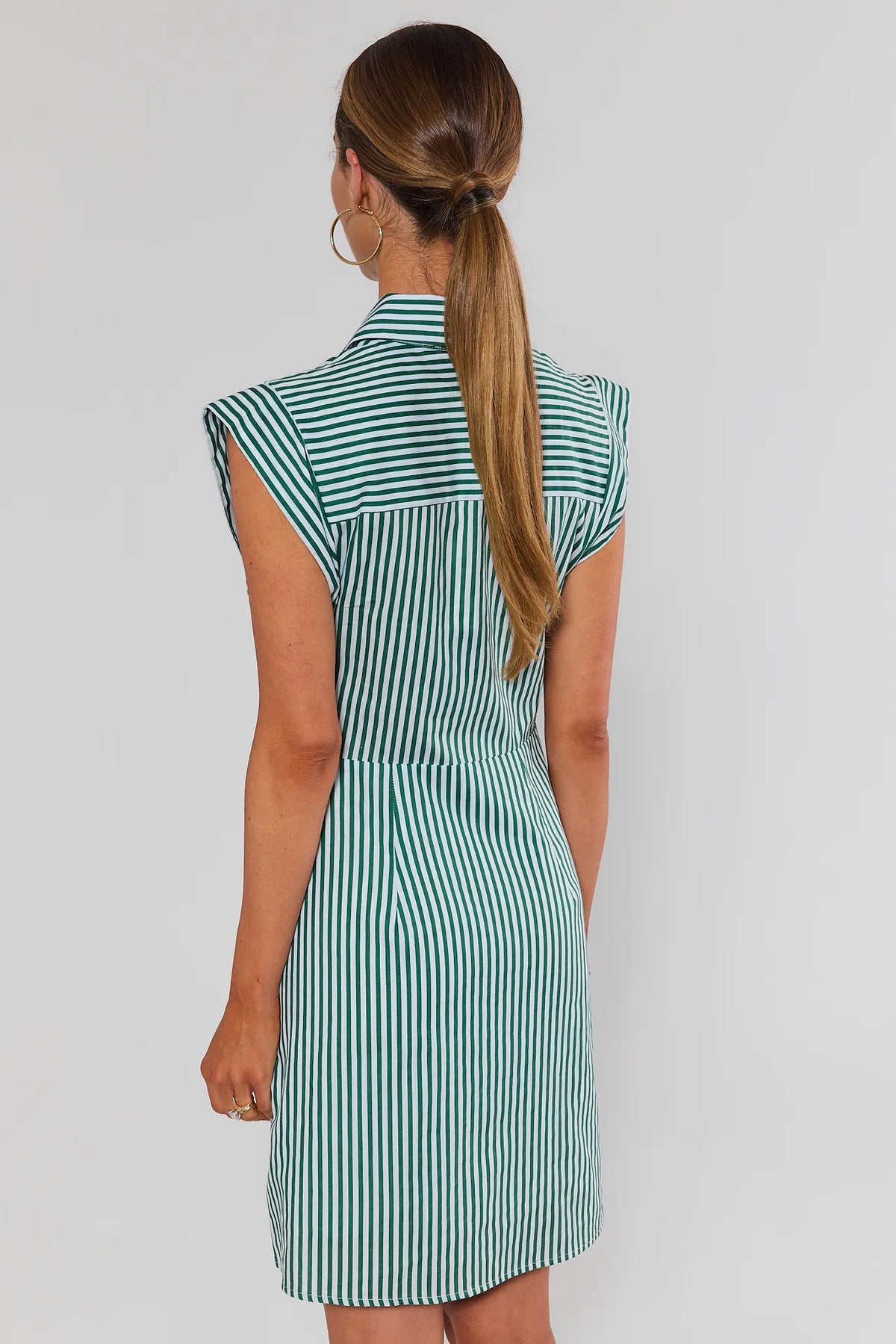 Back view of green and white striped cap sleeve collared short dress showing fitted silhouette and cap sleeve detail | Avara