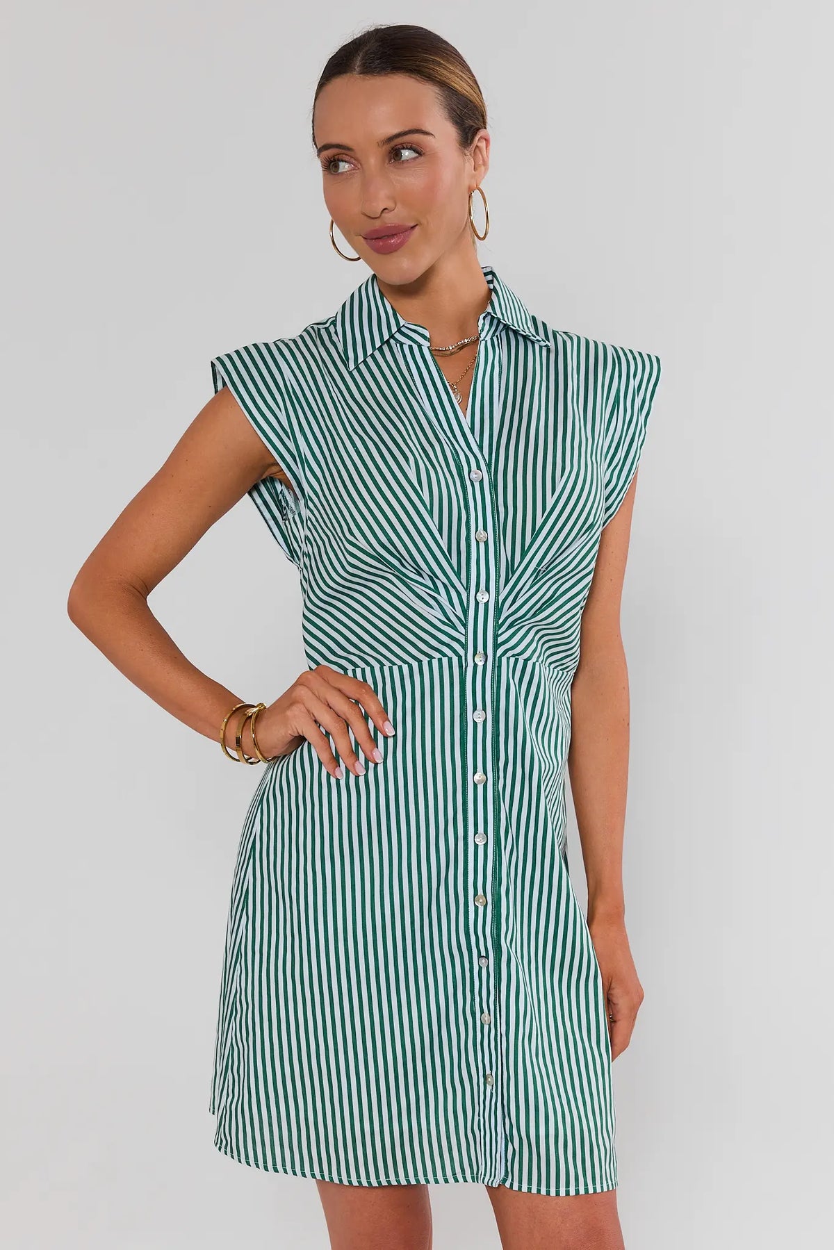 Green and white striped cap sleeve short dress with button-front and collared neckline, front angle on model | Avara
