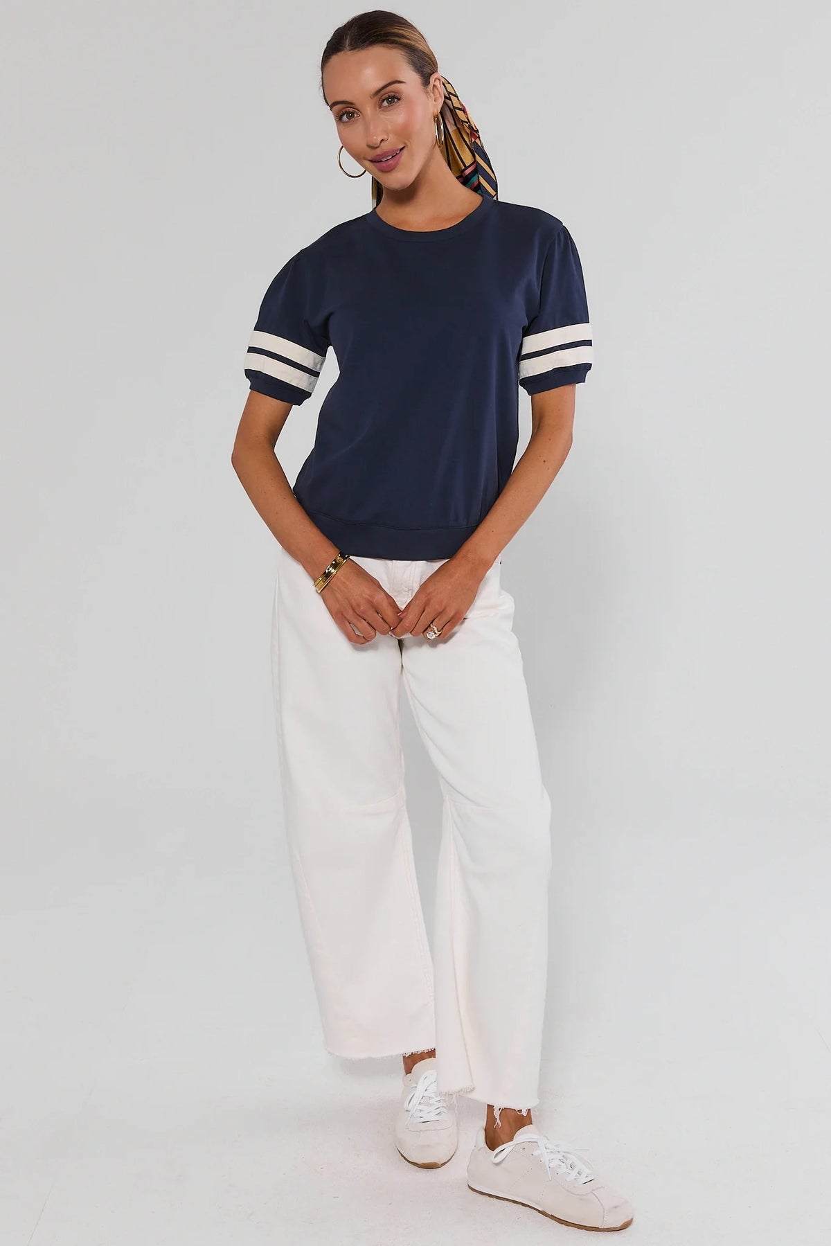 Alice Navy Striped Sleeve Tee - Full Length Front View, styled with white wide-leg pants and sneakers | Avara