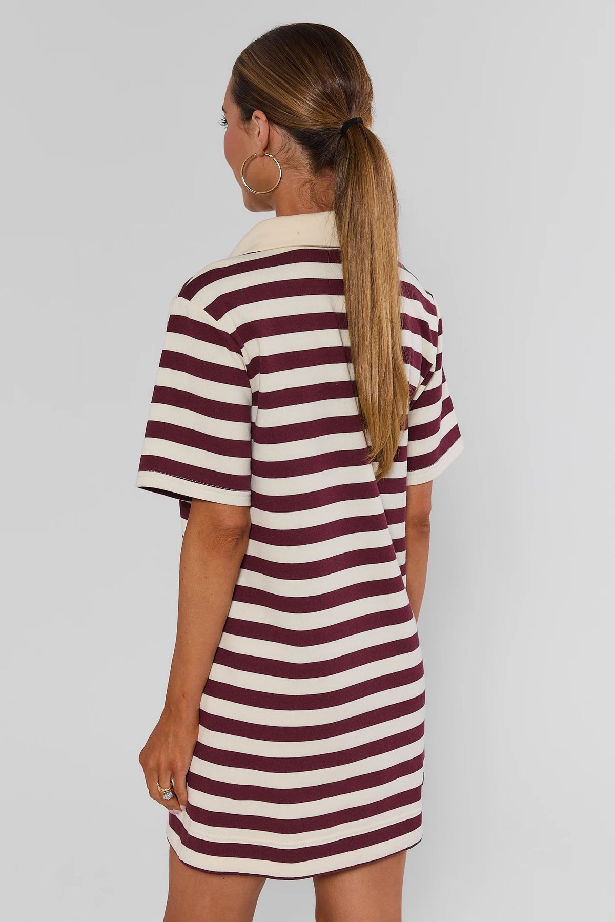 Back view of maroon and cream striped short polo dress showing cream collar and short sleeve silhouette | Avara