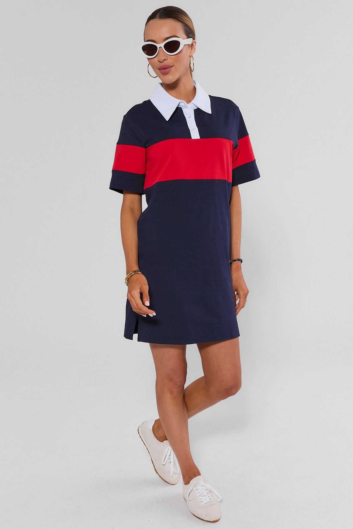 Navy polo dress styled with white sneakers and sunglasses, colorblock red stripe - Full Length View | Avara
