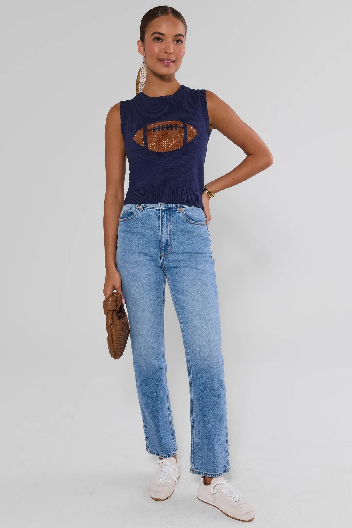 AJ Navy Football Sleeveless Knit Top styled with light wash jeans and white sneakers - Full Length Front View | Avara
