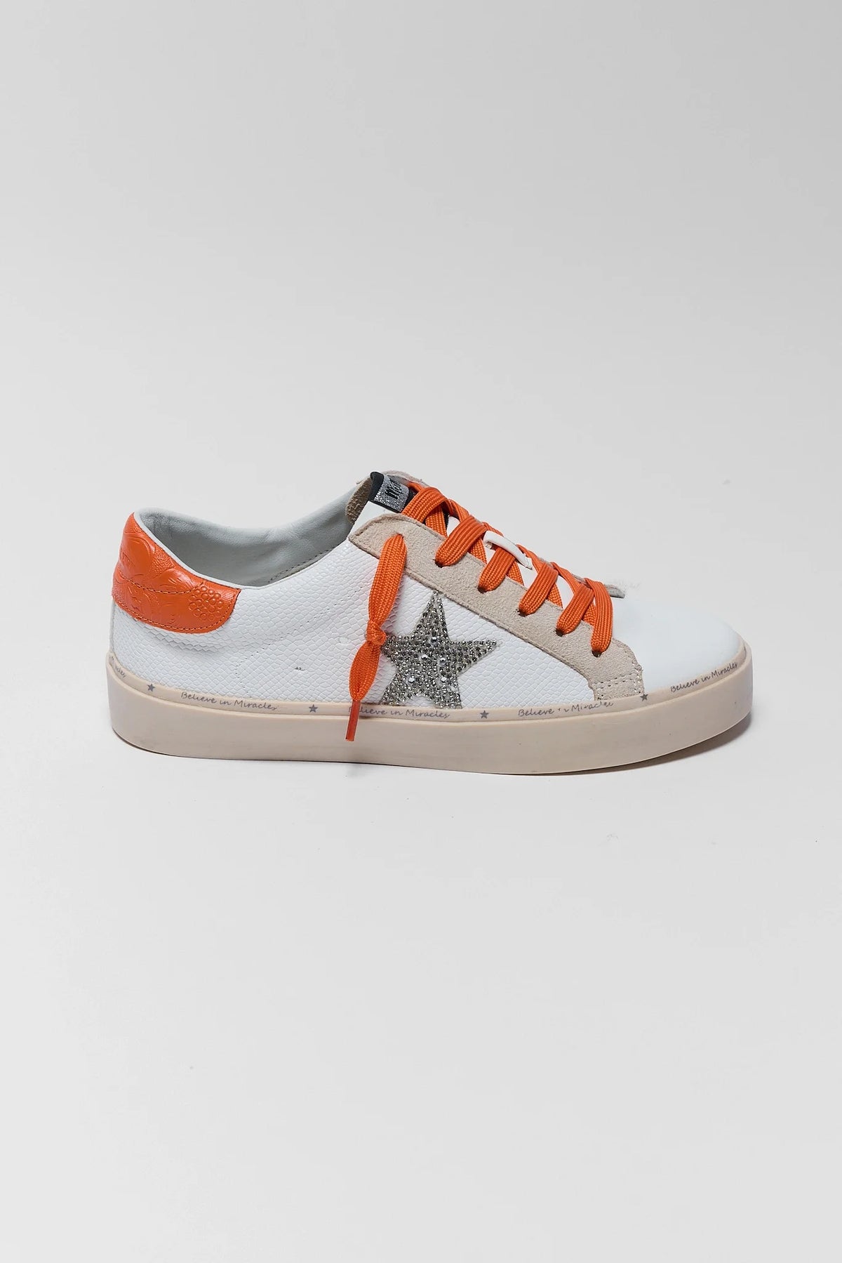White low-top sneaker with rhinestone silver star, orange laces and heel tab - Side Profile | Avara