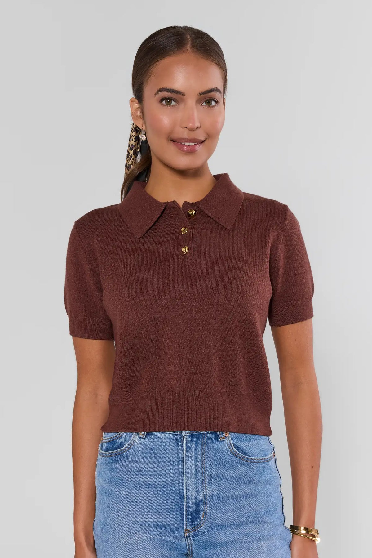 Ada Brown Knit Short Sleeve Top with polo collar and gold buttons, paired with light-wash jeans - Front View | Avara