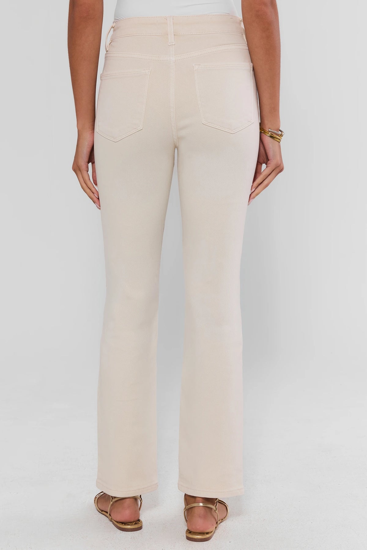 Becca Ecru Straight Leg Jeans showing back pockets, clean straight silhouette, and gold sandals - Back View | Avara