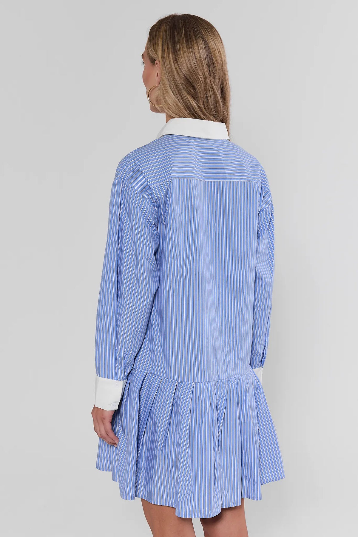 Hannah Blue Striped Collared Short Dress, rear three-quarter view highlighting pleated drop-waist hem and white contrast collar | Avara