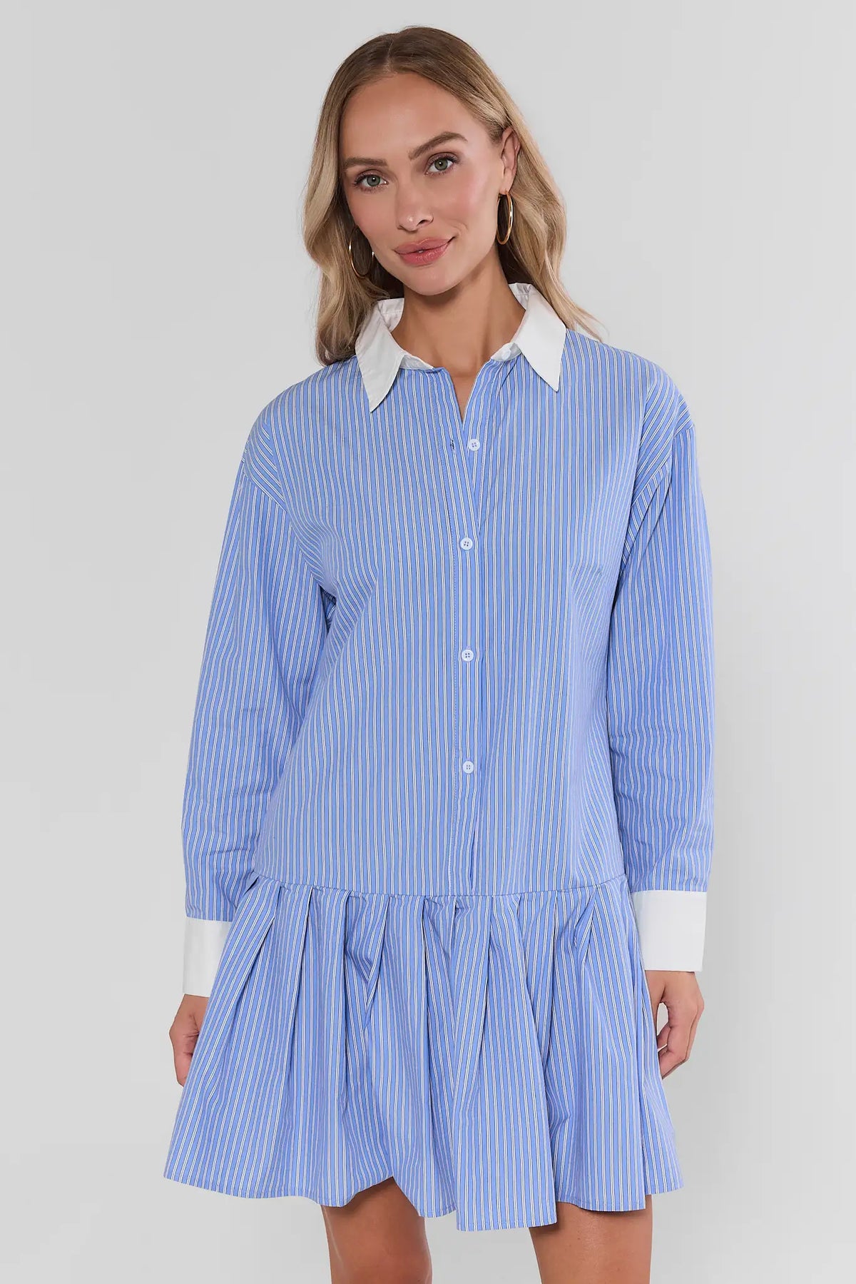 Hannah Blue Striped Collared Short Dress, angled front view showing flared pleated skirt, white contrast cuffs, styled with tan flats | Avara