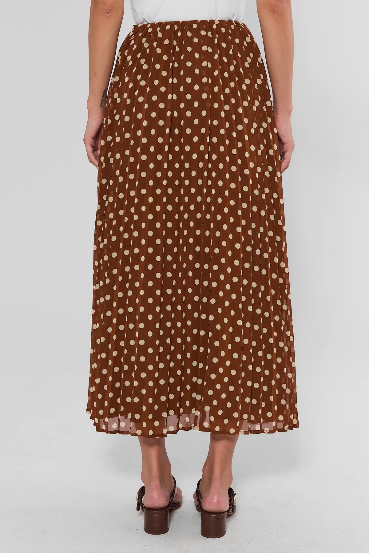 Brown and white polka dot pleated maxi skirt with elastic waist - Back View On Model | Avara