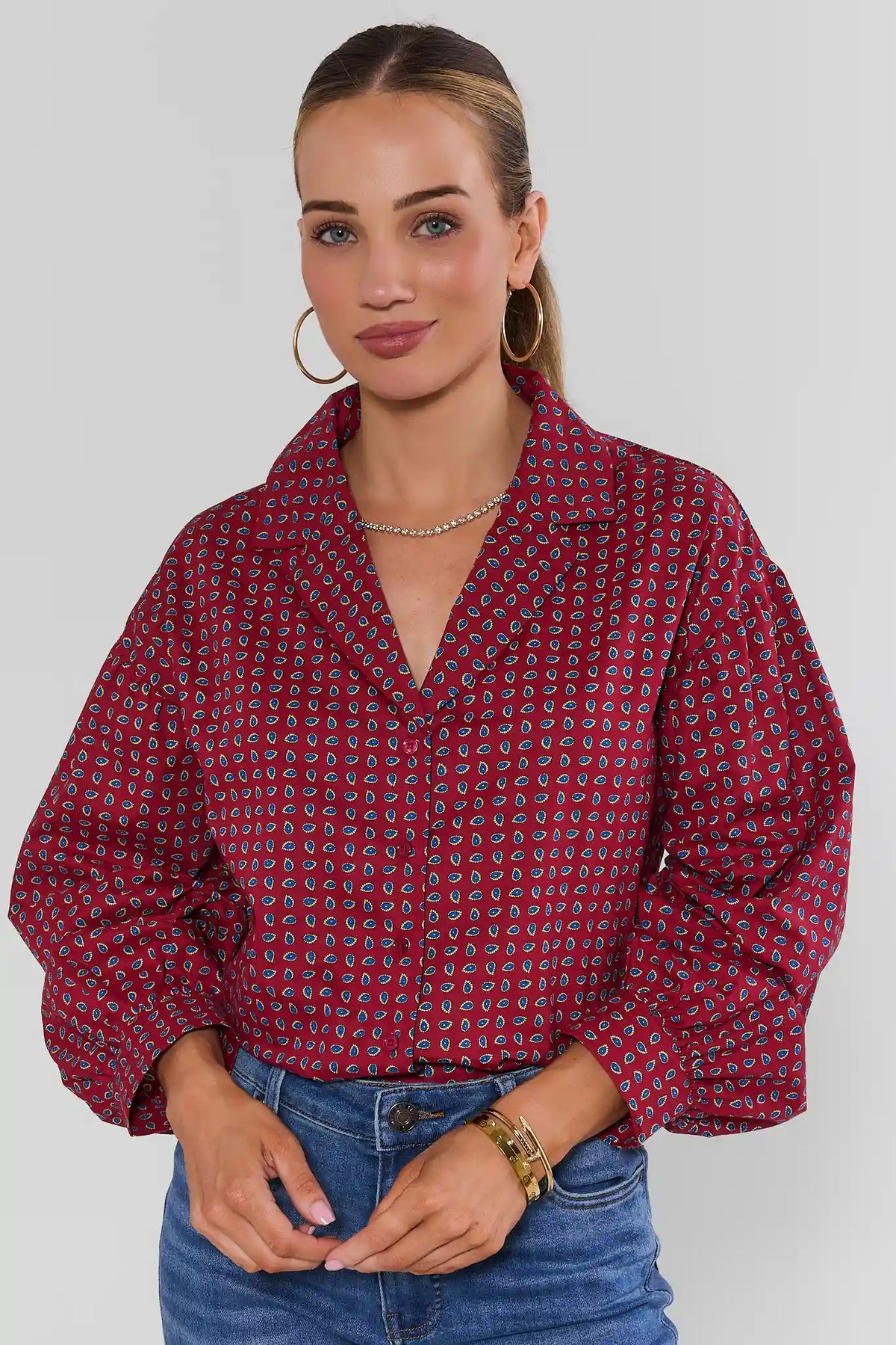 Maroon micro-paisley printed button-up top with puff sleeves, paired with blue jeans - Front View | Avara