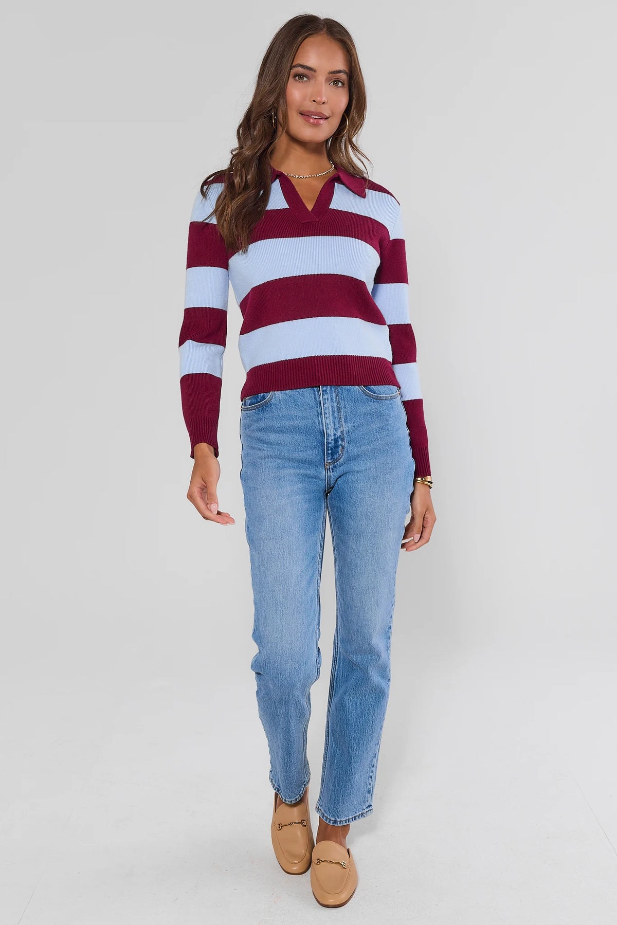 Maroon and blue striped polo sweater styled with straight-leg jeans and tan loafers, full-length front view | Avara