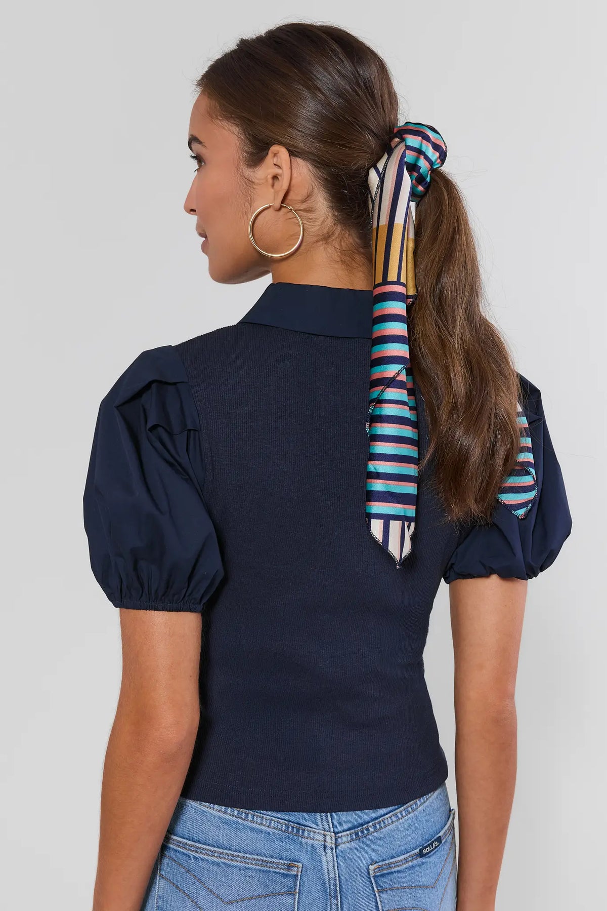 Navy Collared Polo Top back view showing ribbed knit fit and puff sleeves, styled with a colorful striped hair scarf | Avara
