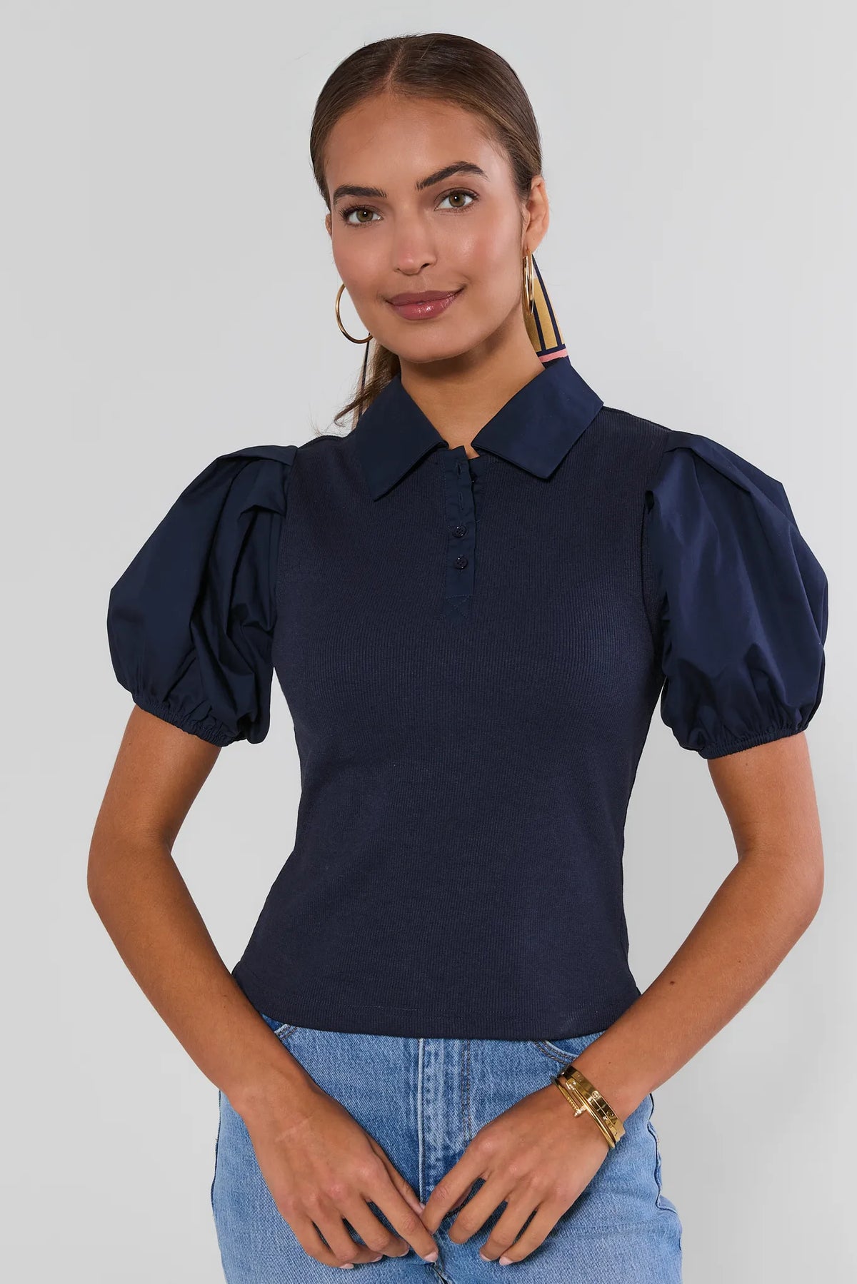 Navy Collared Polo Top with puff sleeves and ribbed knit bodice, front view styled with light wash jeans | Avara