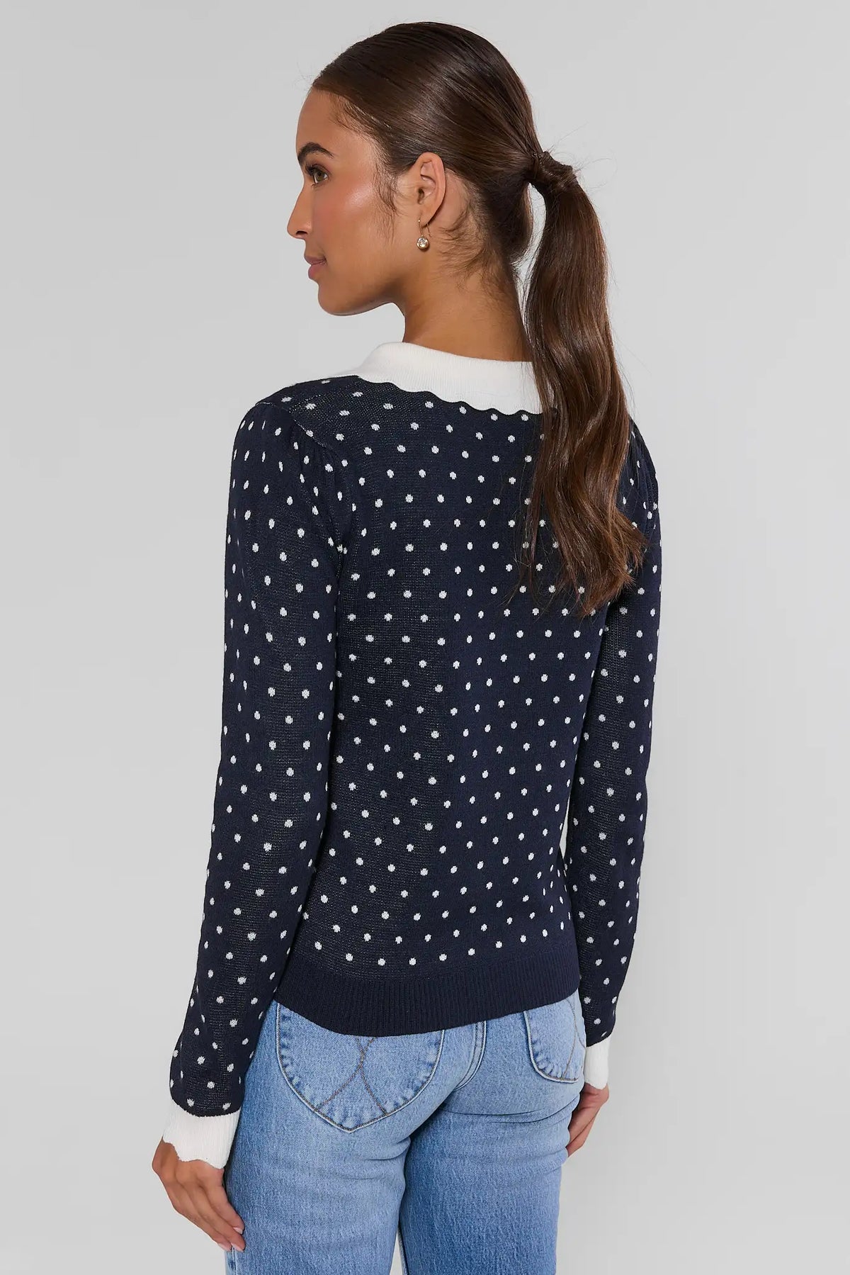 Navy polka dot cardigan sweater showing allover dot knit and white contrast collar detail - Back View | Avara