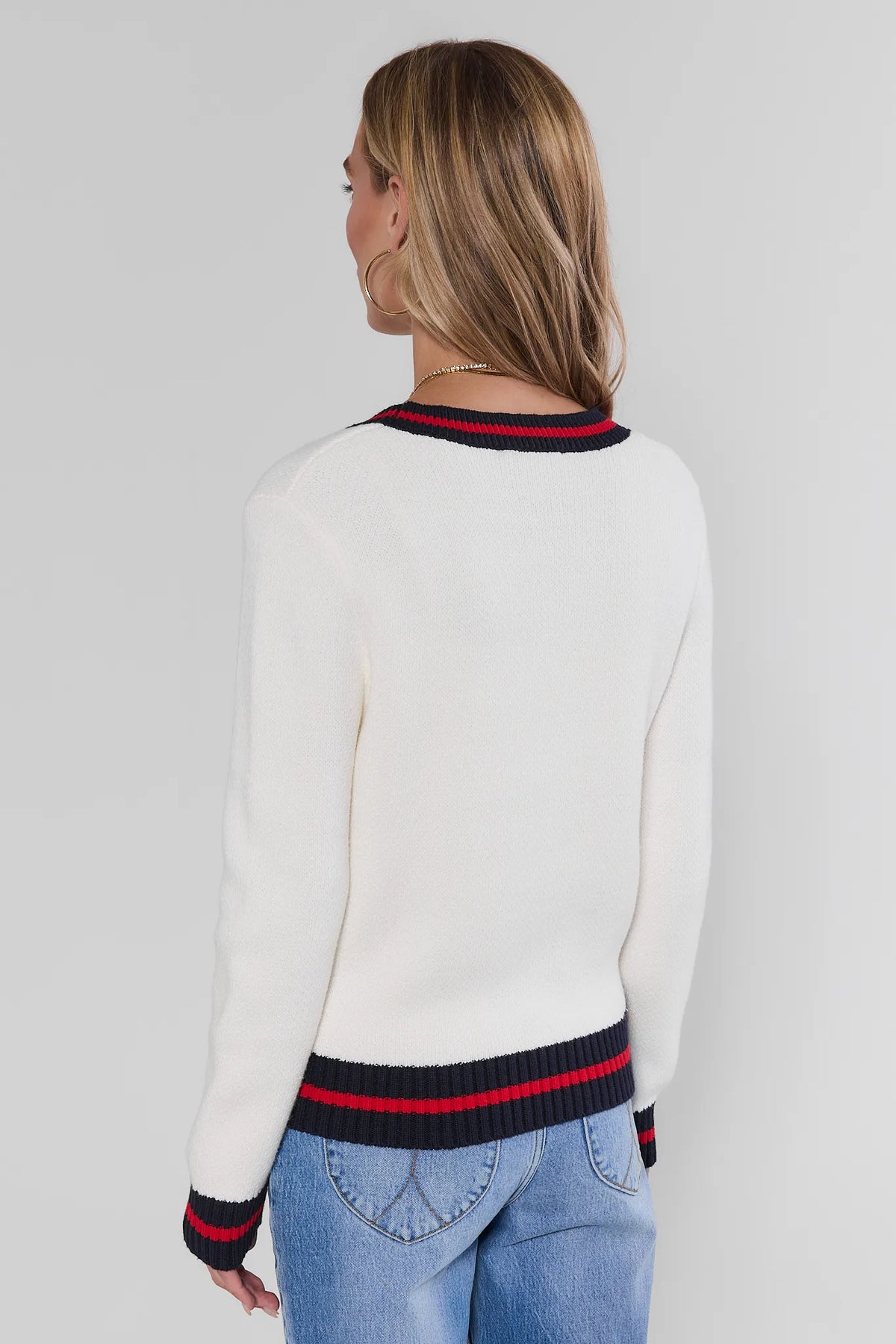 White striped trim cardigan showing navy and red ribbed trim at back neckline, hem, and cuffs - Back View | Avara