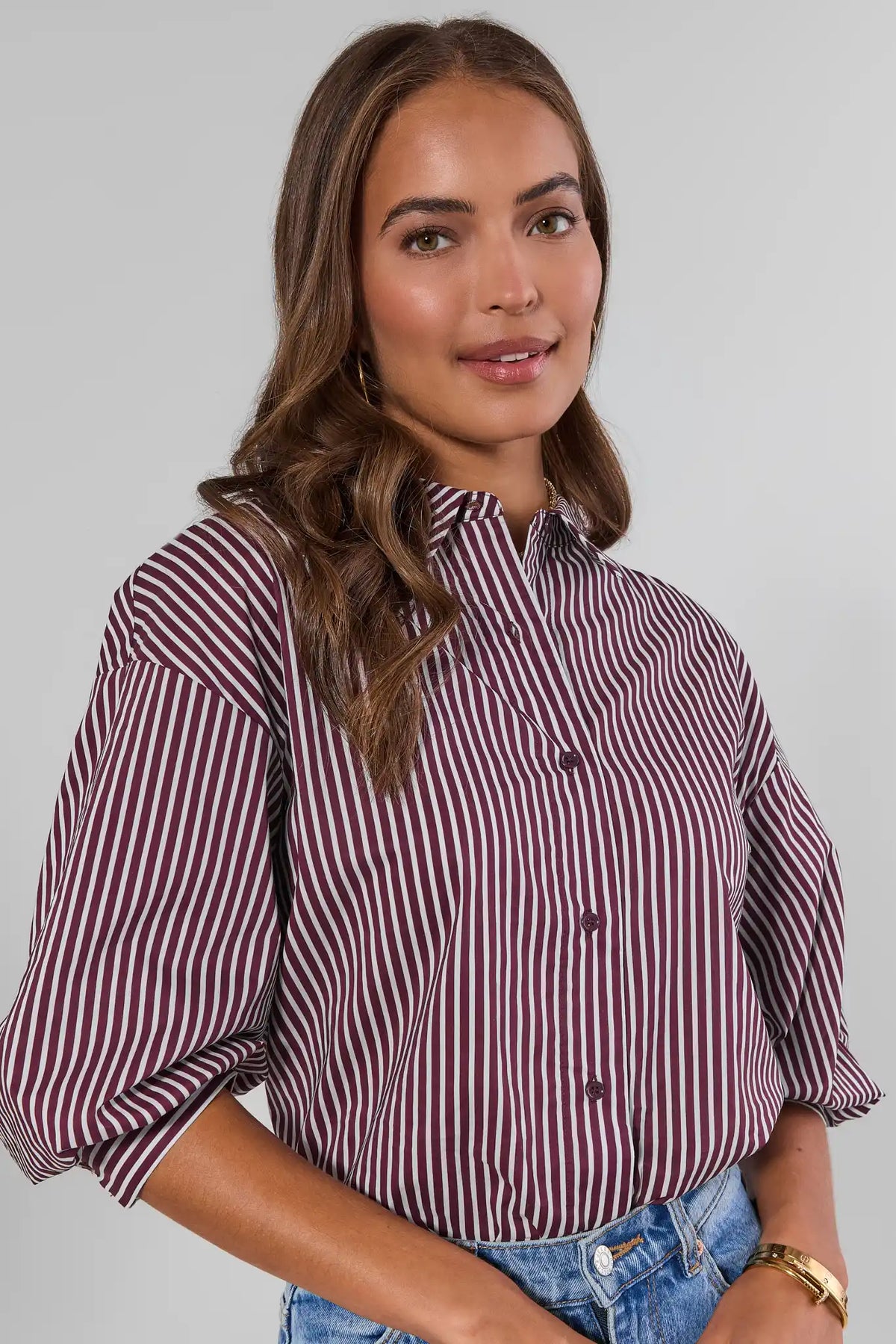 Close-up of burgundy and white striped button-up shirt with spread collar, 3/4 sleeve detail | Avara