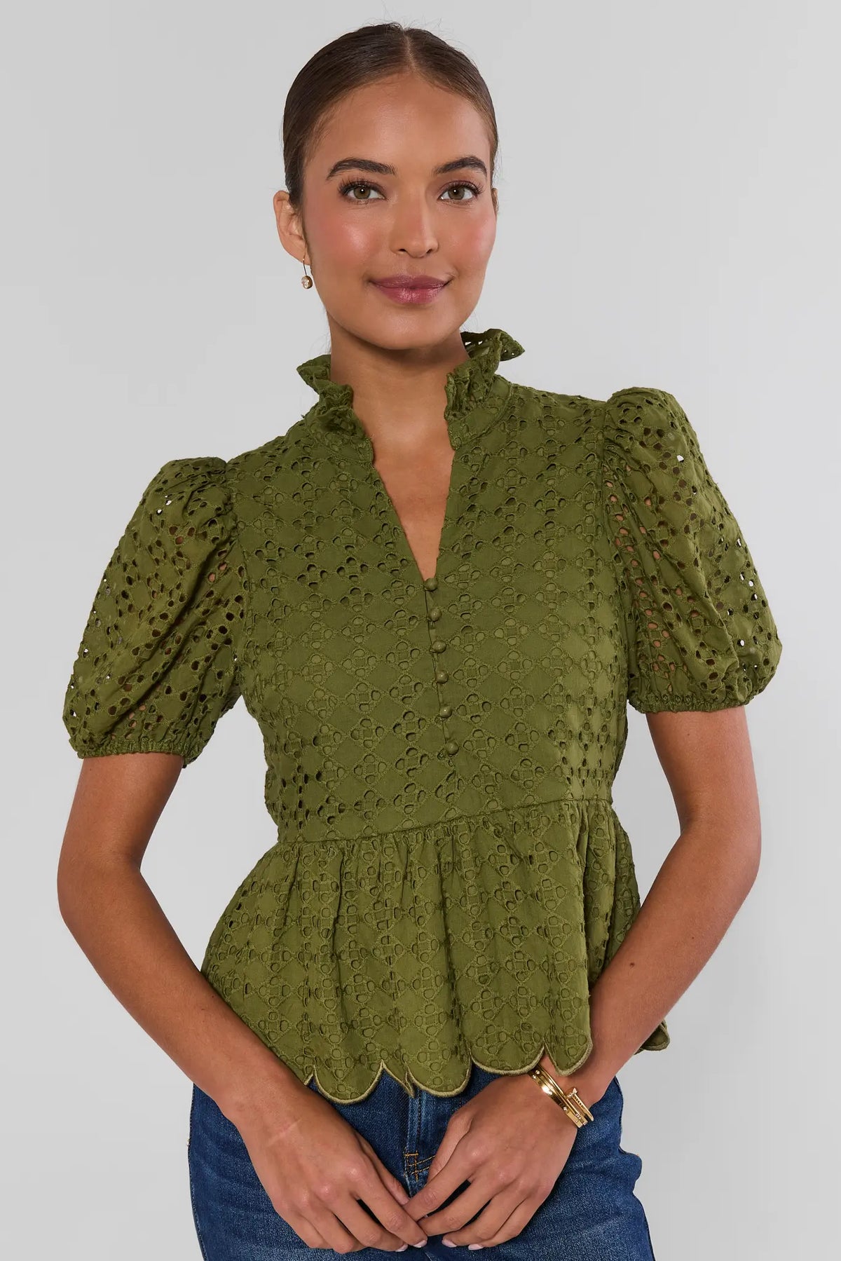 Olive green eyelet peplum top with puff sleeves, ruffled V-neckline, and scalloped hem - Front View | Avara