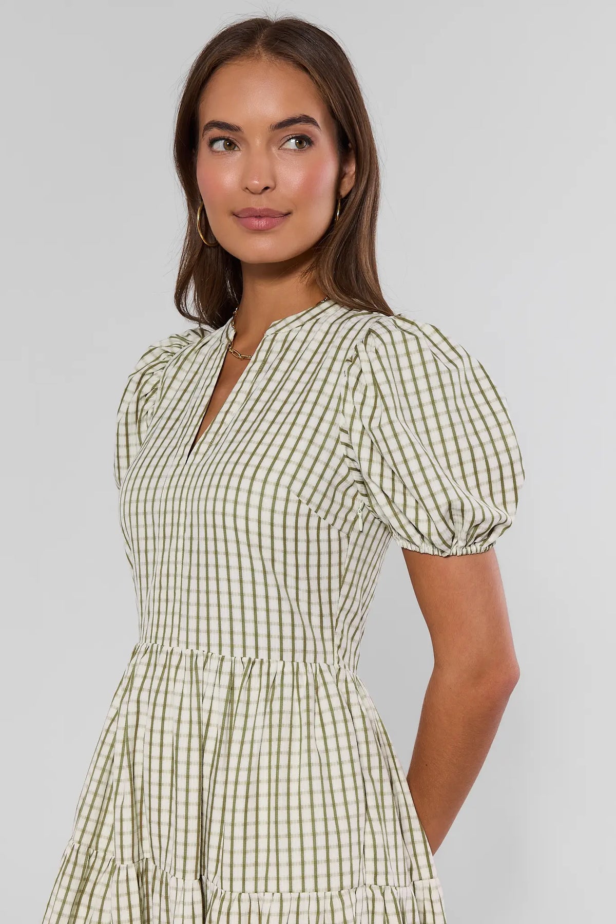 Green plaid modest midi dress split neckline and puff sleeve close-up detail, angled view | Avara