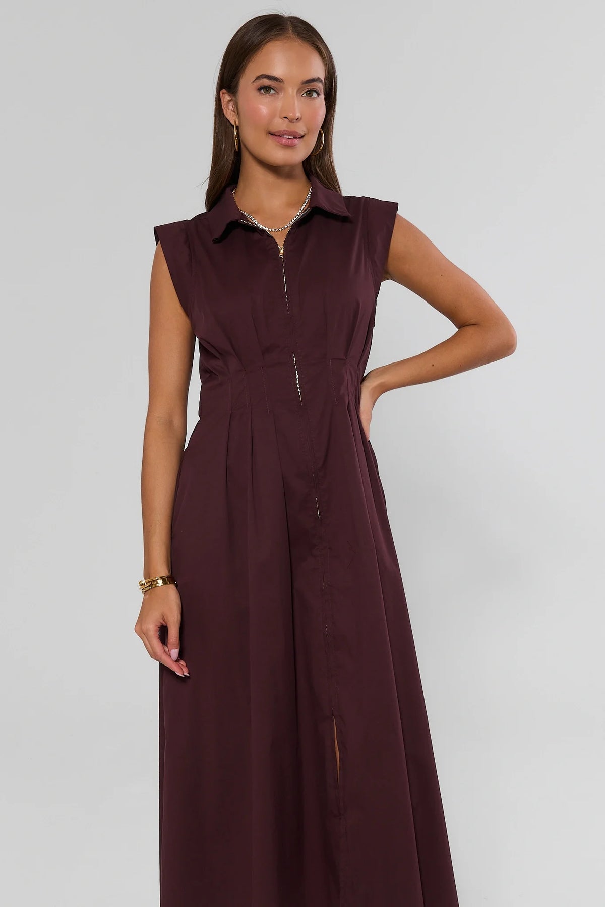 Deep burgundy zip-up midi dress with spread collar and pleated bodice, front view on model | Avara