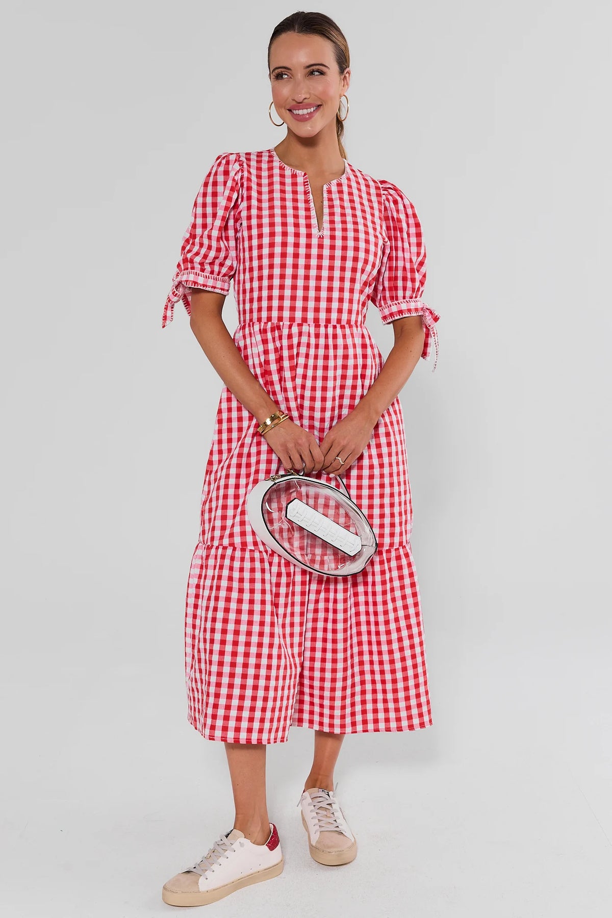 Hazel Red Gingham Midi Dress full-length front view styled with sneakers and clear oval clutch | Avara