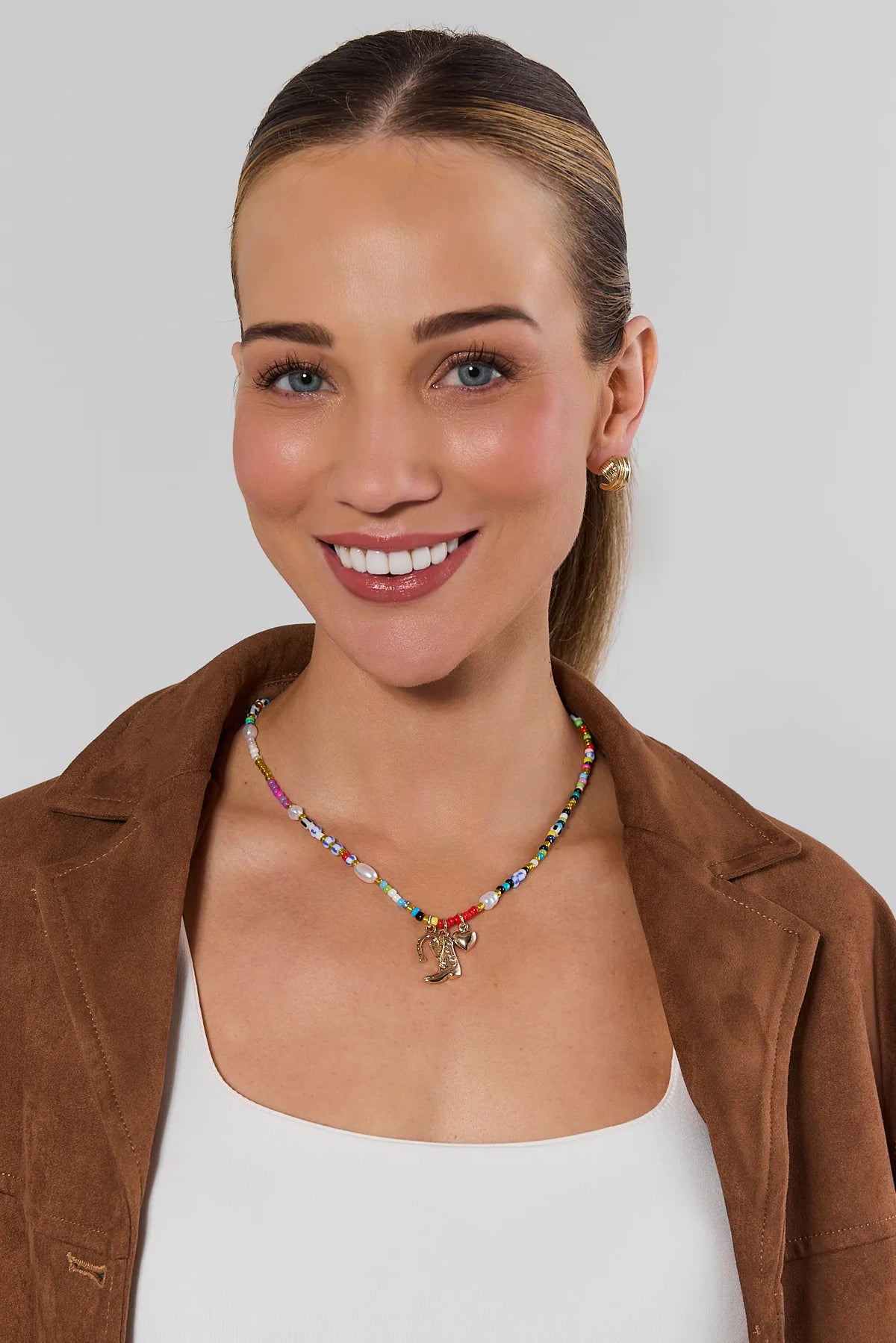 Multi Beaded Boot Charm Necklace On Model with Brown Suede Jacket - Front View | Avara