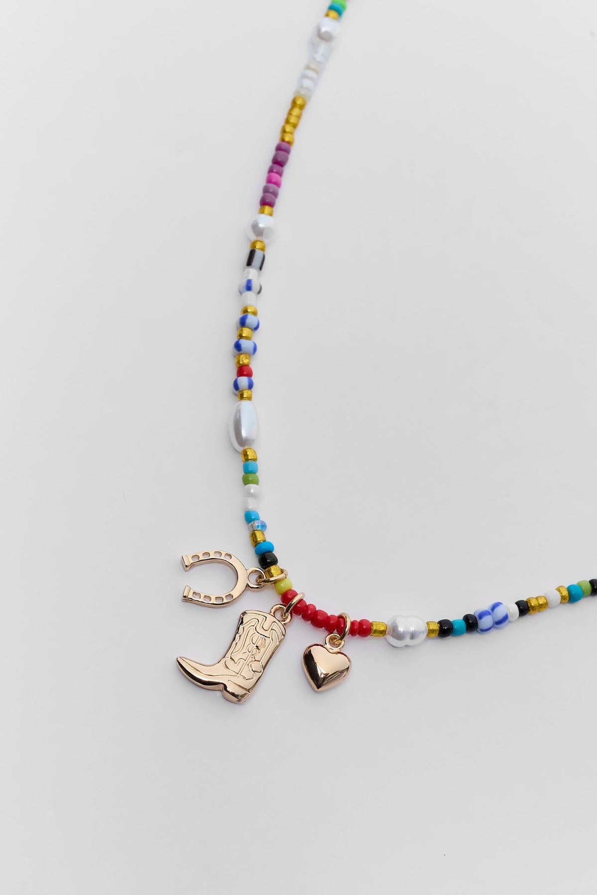Gold Cowboy Boot Horseshoe Heart Charm Detail on Multi Beaded Necklace - Close Up | Avara
