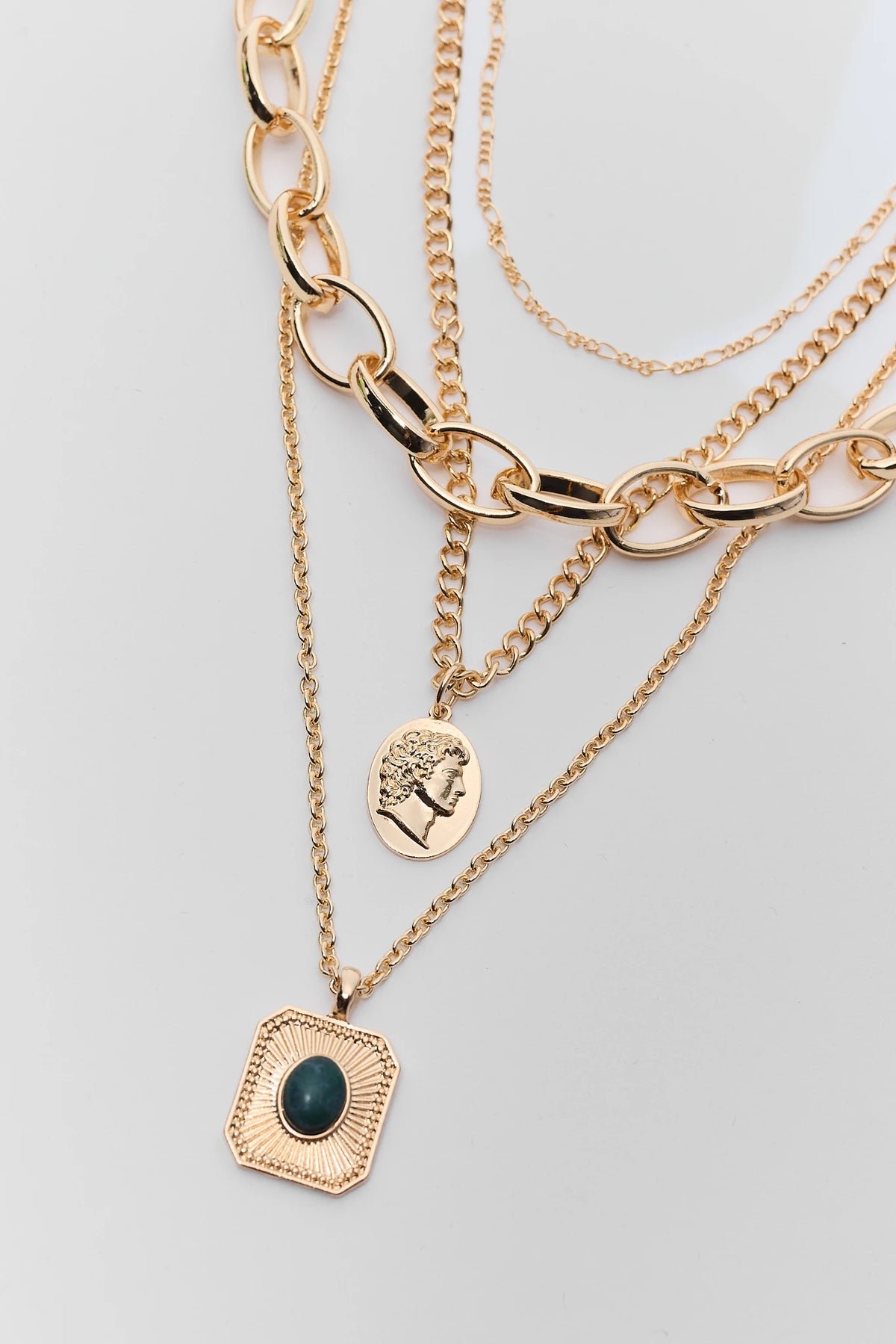Gold Chain Necklace Stack - Close-Up of Coin and Green Stone Pendant Detail | Avara