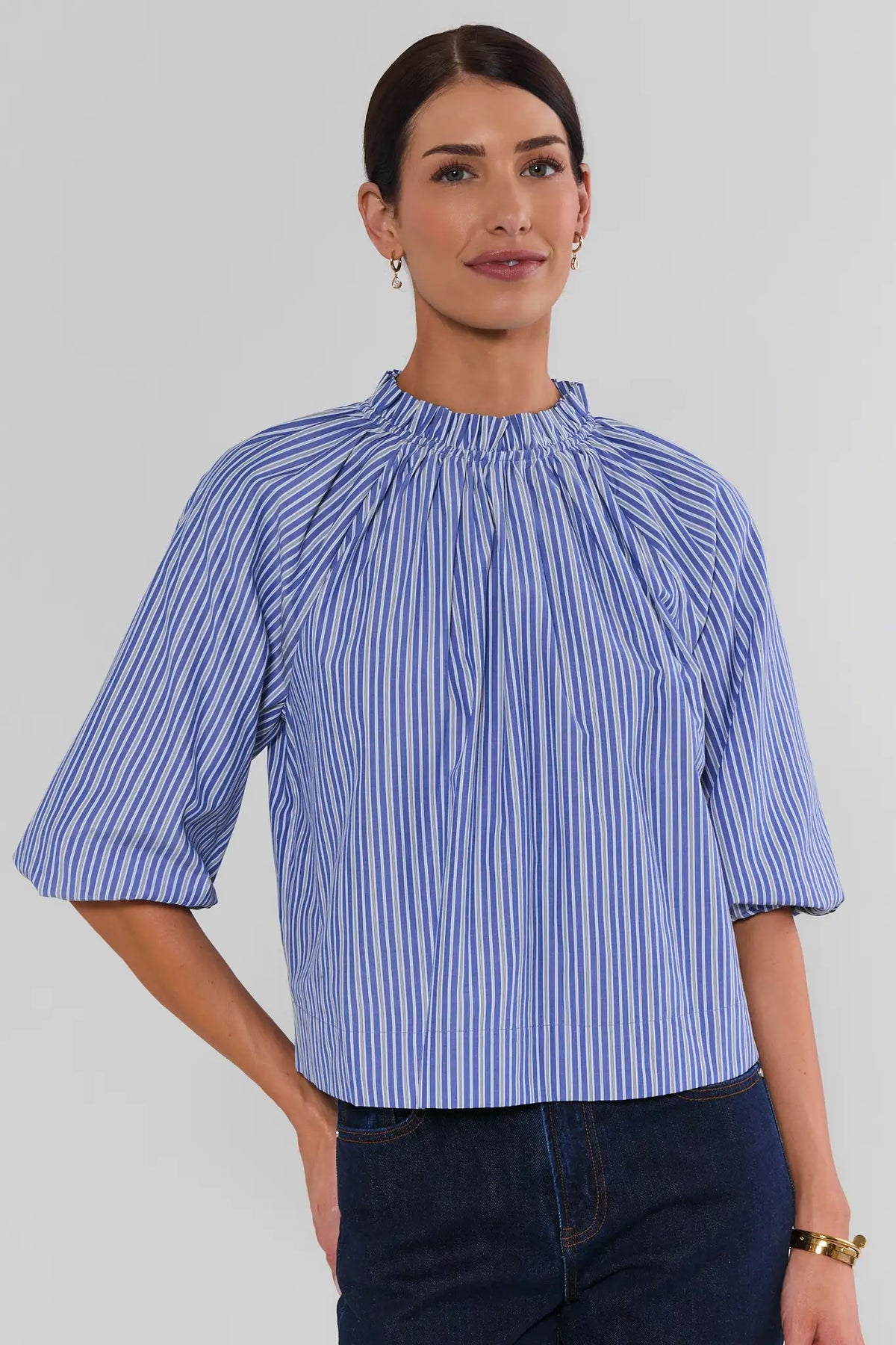 Blue Striped Ruffle Collar Top with gathered mock neck, 3/4 puff sleeves, relaxed fit, styled with dark denim - Front View | Avara
