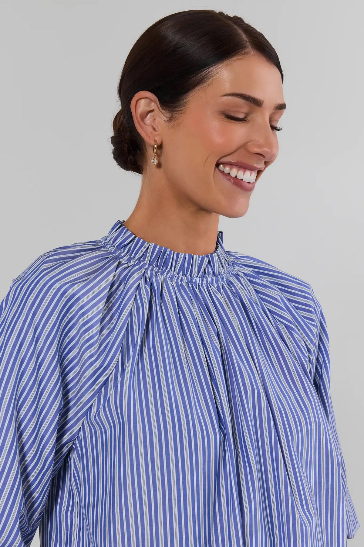Blue and white striped ruffle collar blouse close-up detail showing gathered smocked neckline and puff sleeve - Neck Detail | Avara