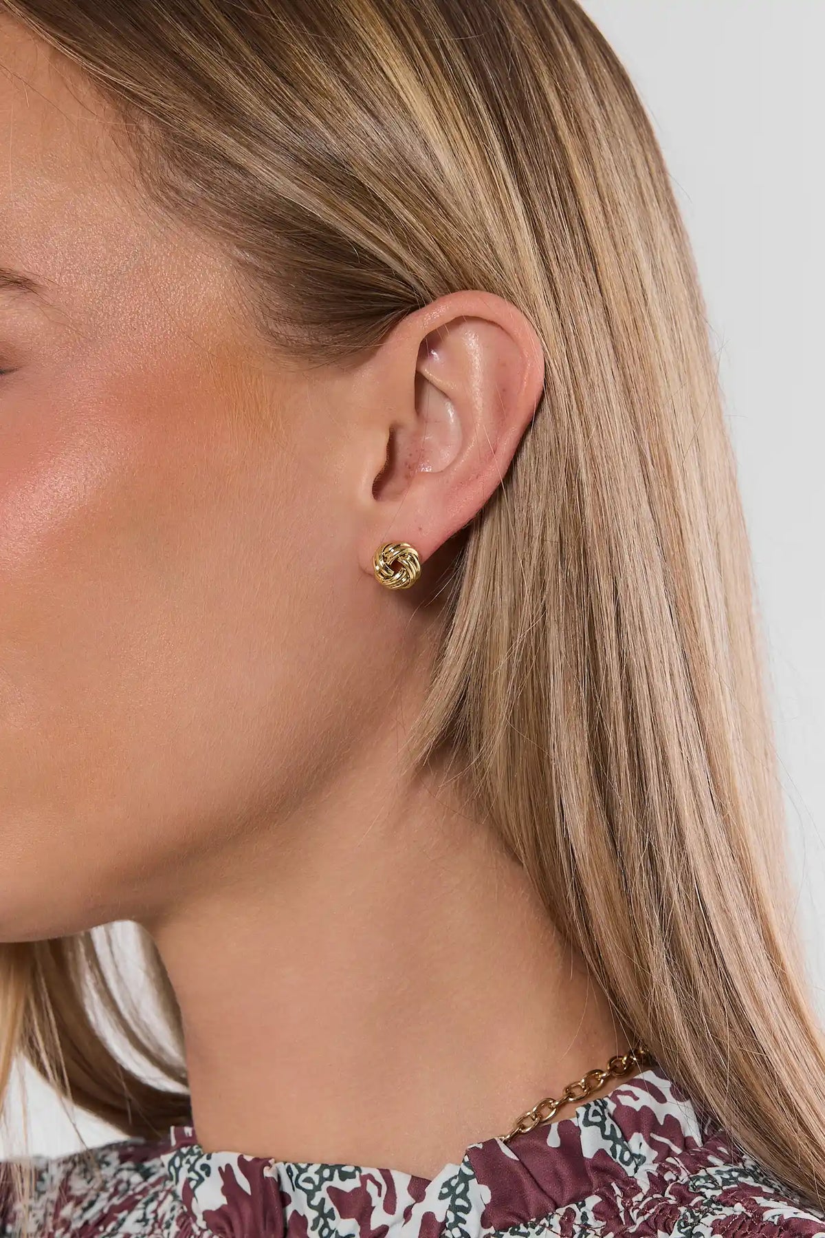 Cute Gold Knot Stud Earrings - On Model Ear View, Small Gold Knot Studs | Avara